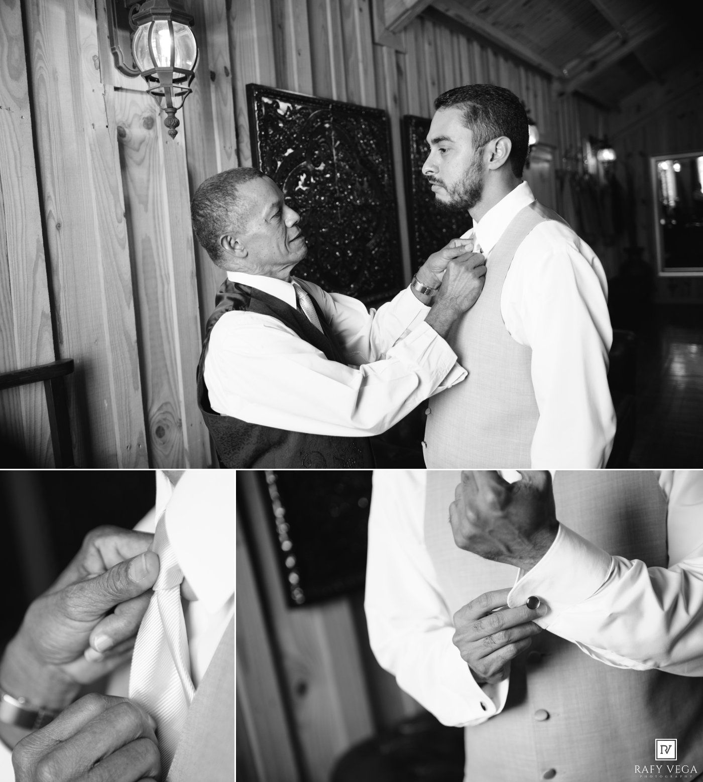 Black and white photo of a man helping a groom adjust his bow tie before a wedding ceremony.