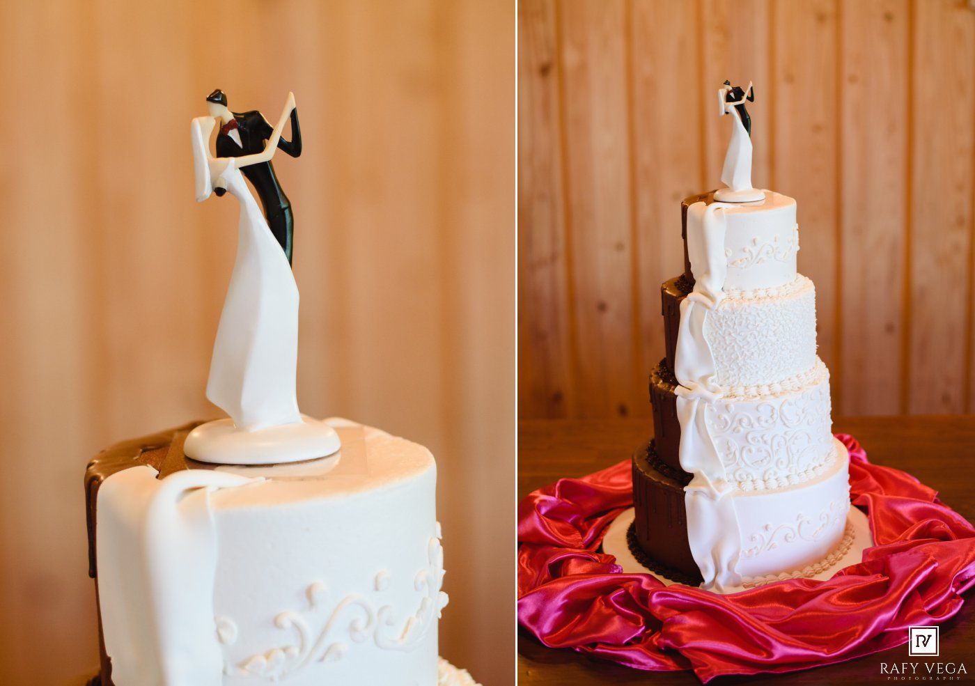 Elegant white wedding cake with bride and groom topper displayed on red satin fabric at a rustic venue.