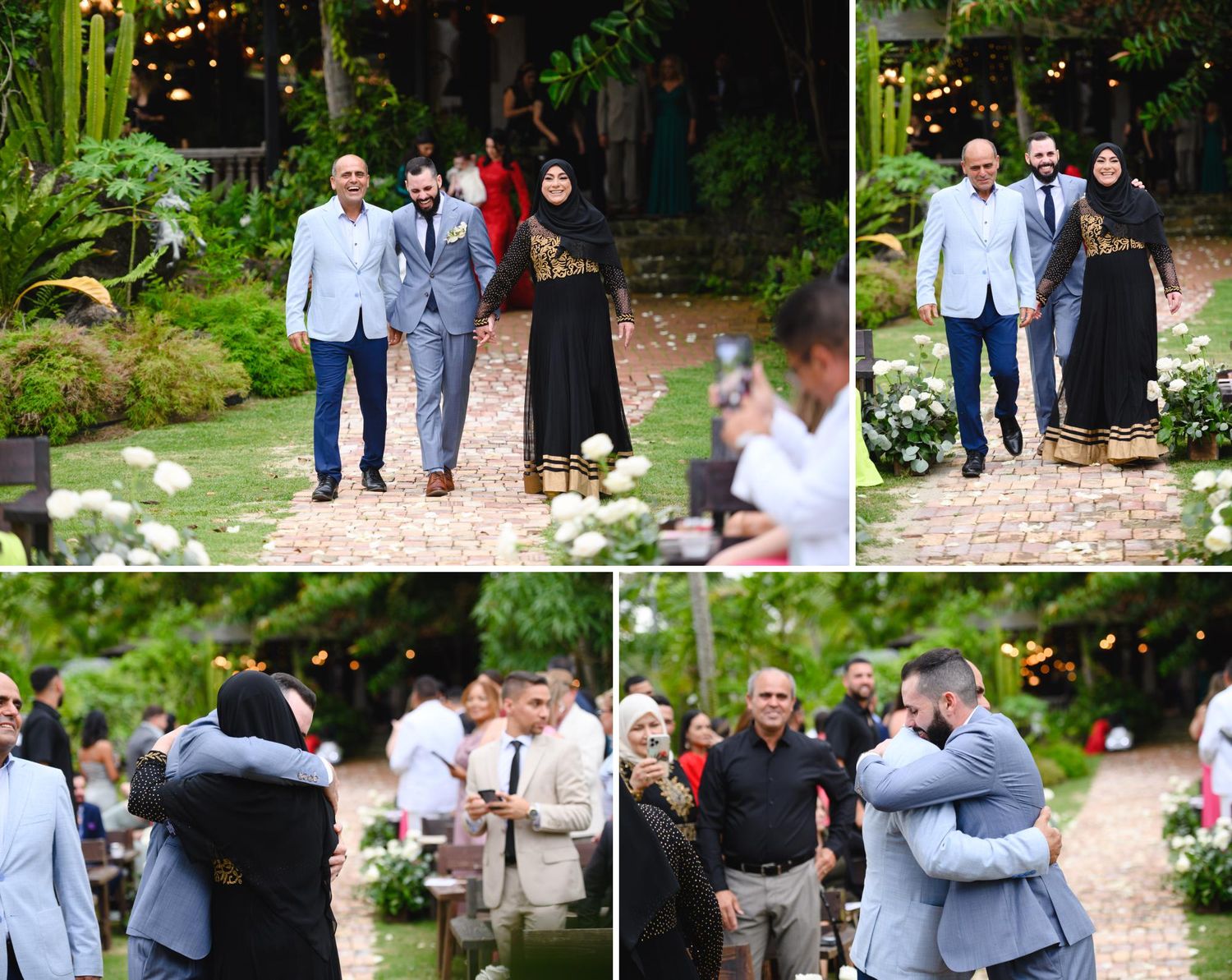 Guests walk down an outdoor wedding aisle amid lush greenery, sharing warm embraces during the ceremony.