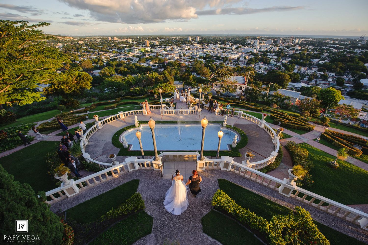 Aerial view of bride and groom at elegant garden wedding venue.