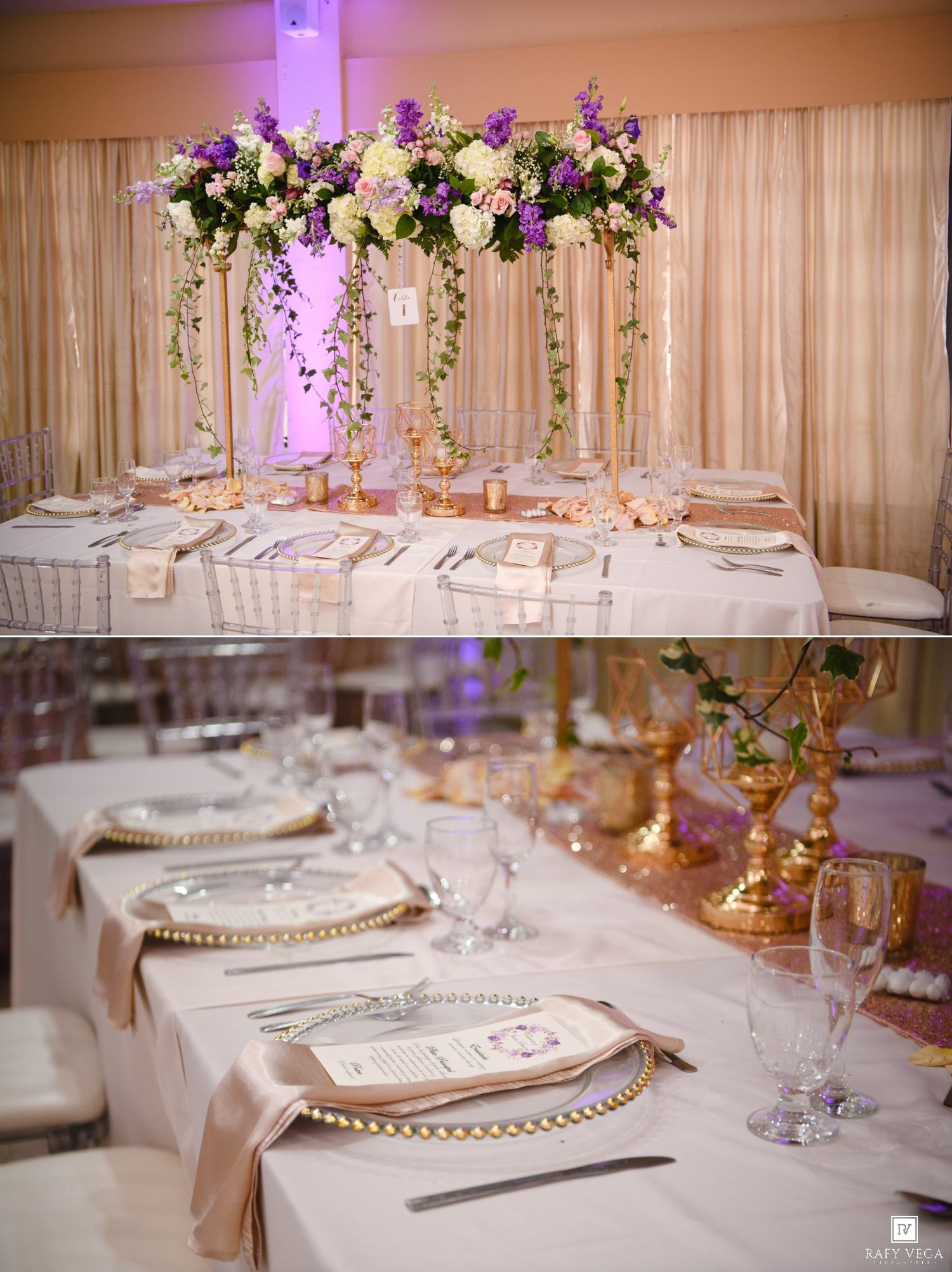 Elegant wedding reception table with tall floral centerpiece in purple and white, gold charger plates, and crystal glassware.
