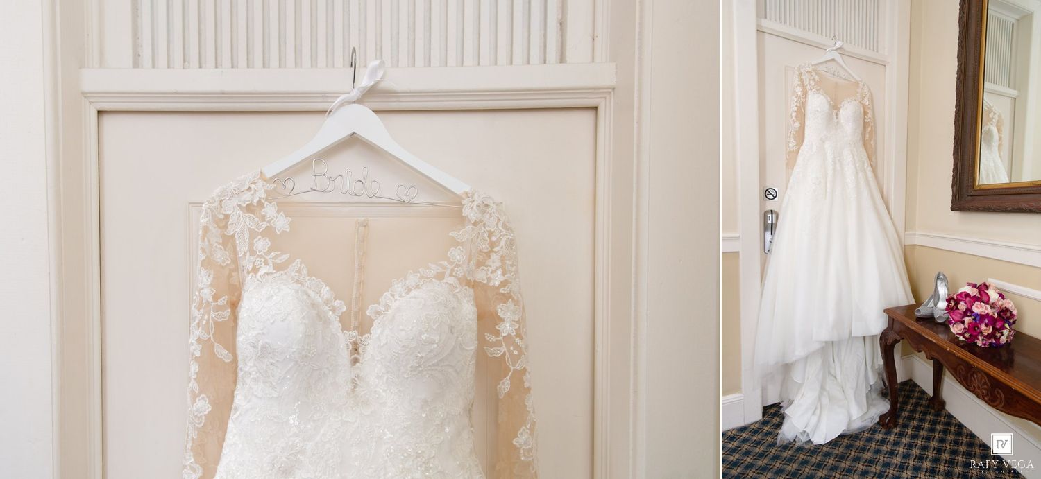 Elegant lace wedding dress with long sleeves hanging on a door beside a flowing white bridal gown displayed in a classic room.