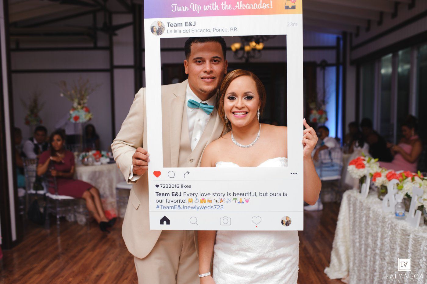 Bride and groom posing with a decorative Instagram photo frame prop at their wedding reception.
