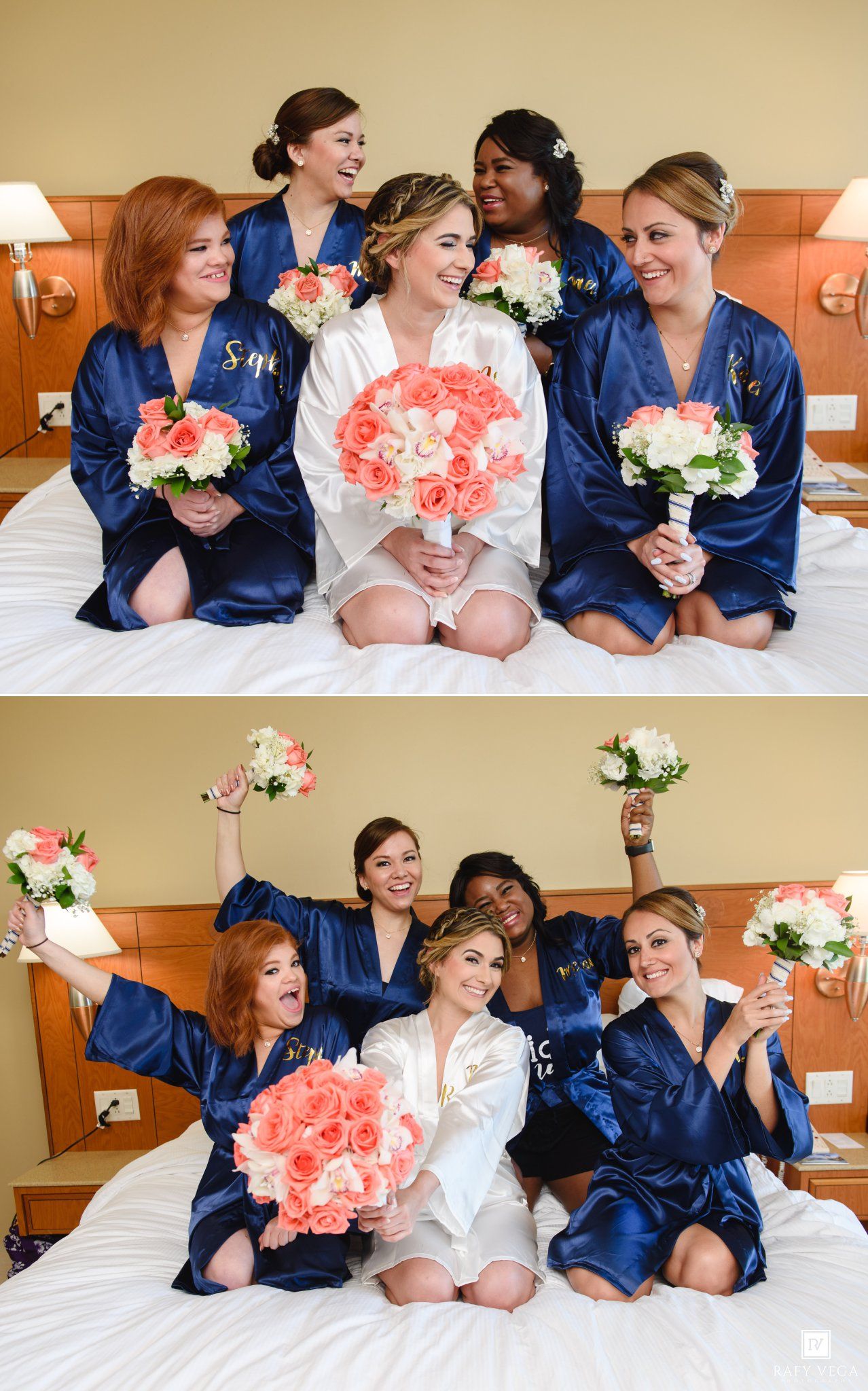Bride and bridesmaids in navy monogrammed robes sitting on hotel bed holding coral and white bouquets.