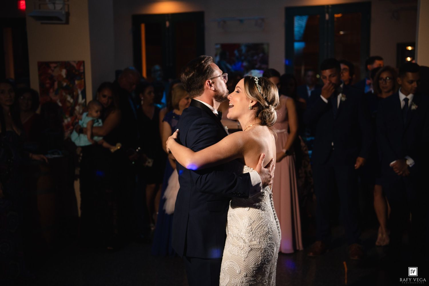Couple shares a tender first dance embrace at elegant wedding reception celebration.
