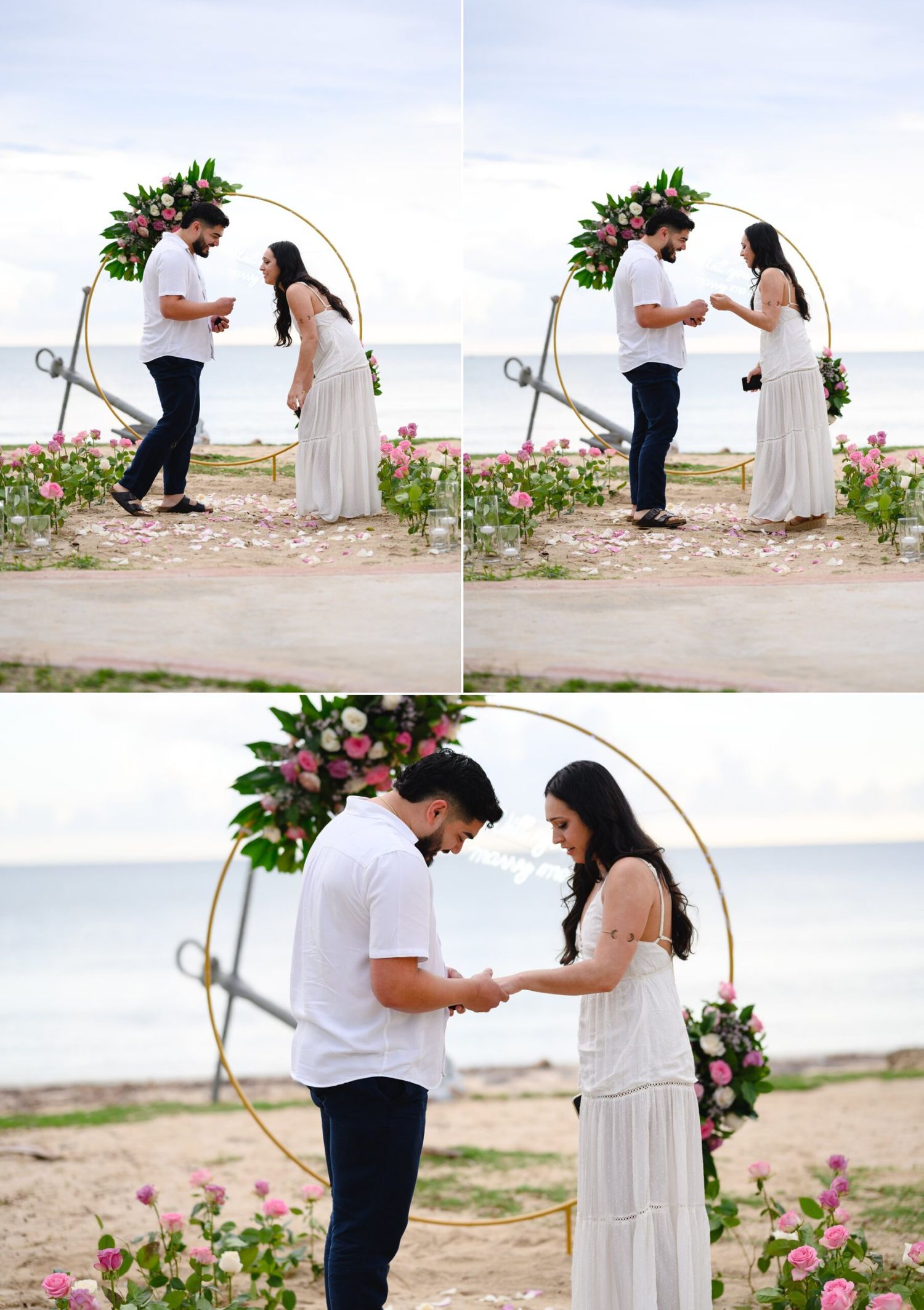 Couple exchanging vows at a beach wedding under a floral hoop arch decorated with pink roses and tropical greenery.