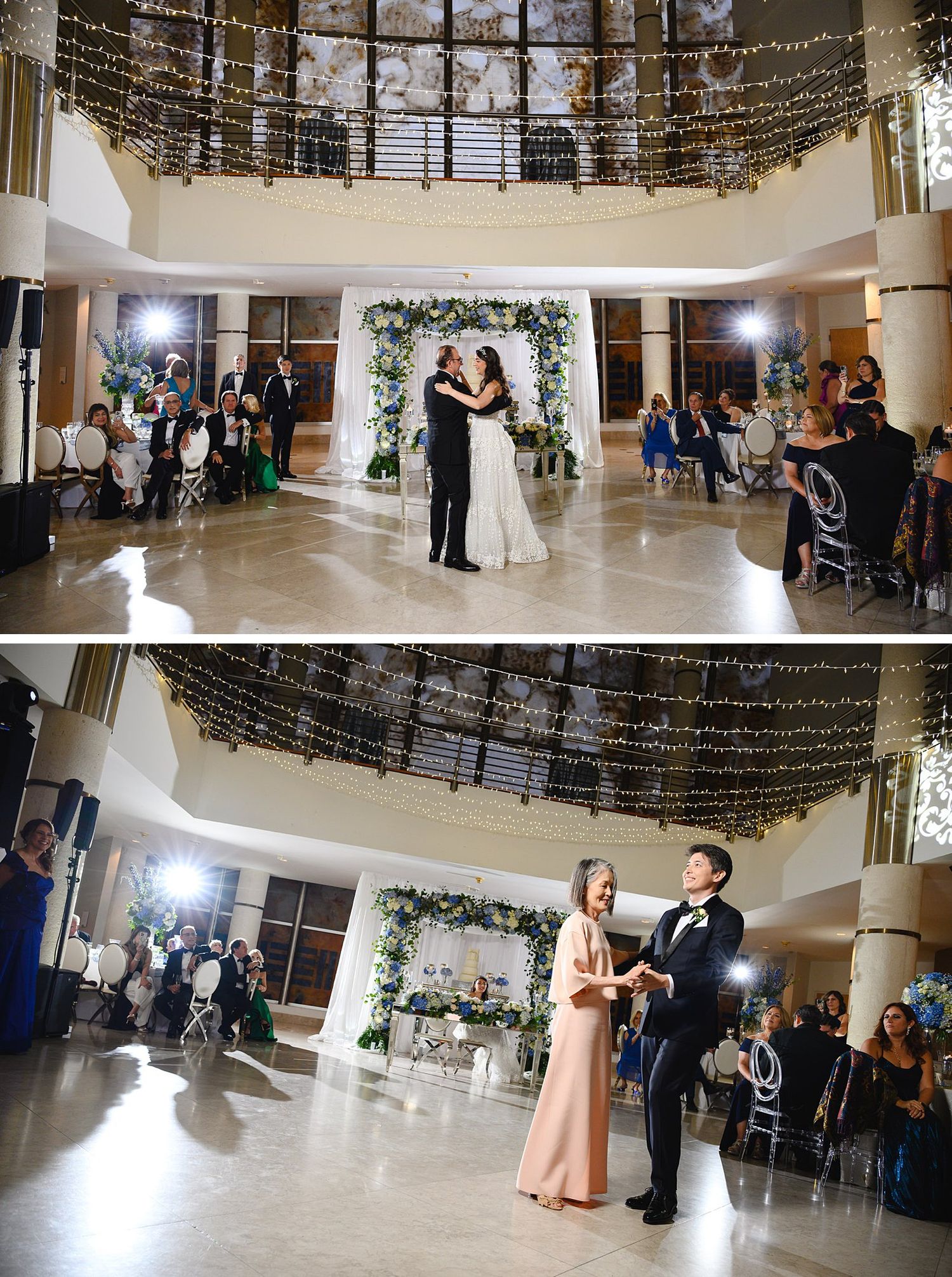 Bride and groom share first dance at elegant wedding reception with fairy lights and floral arch backdrop.