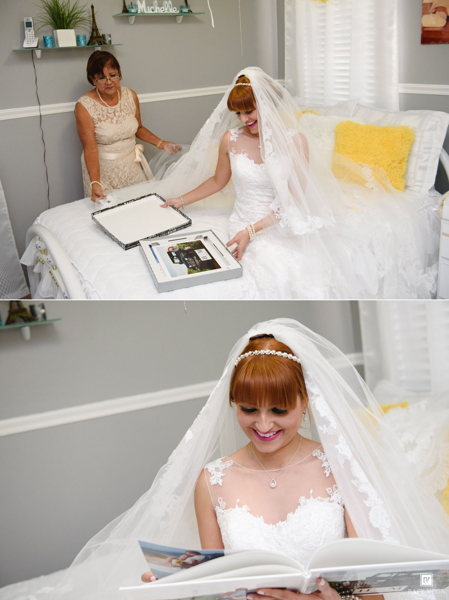 Red-haired bride in white gown and veil reviewing wedding album with mother before ceremony.