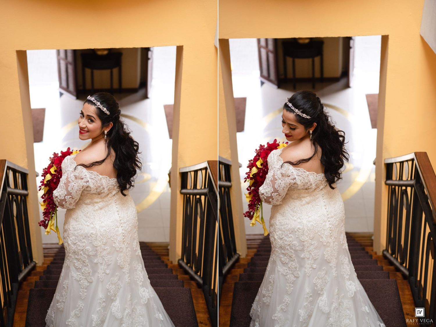 Bride in lace wedding gown holding red bouquet smiles on staircase, wearing floral headpiece.