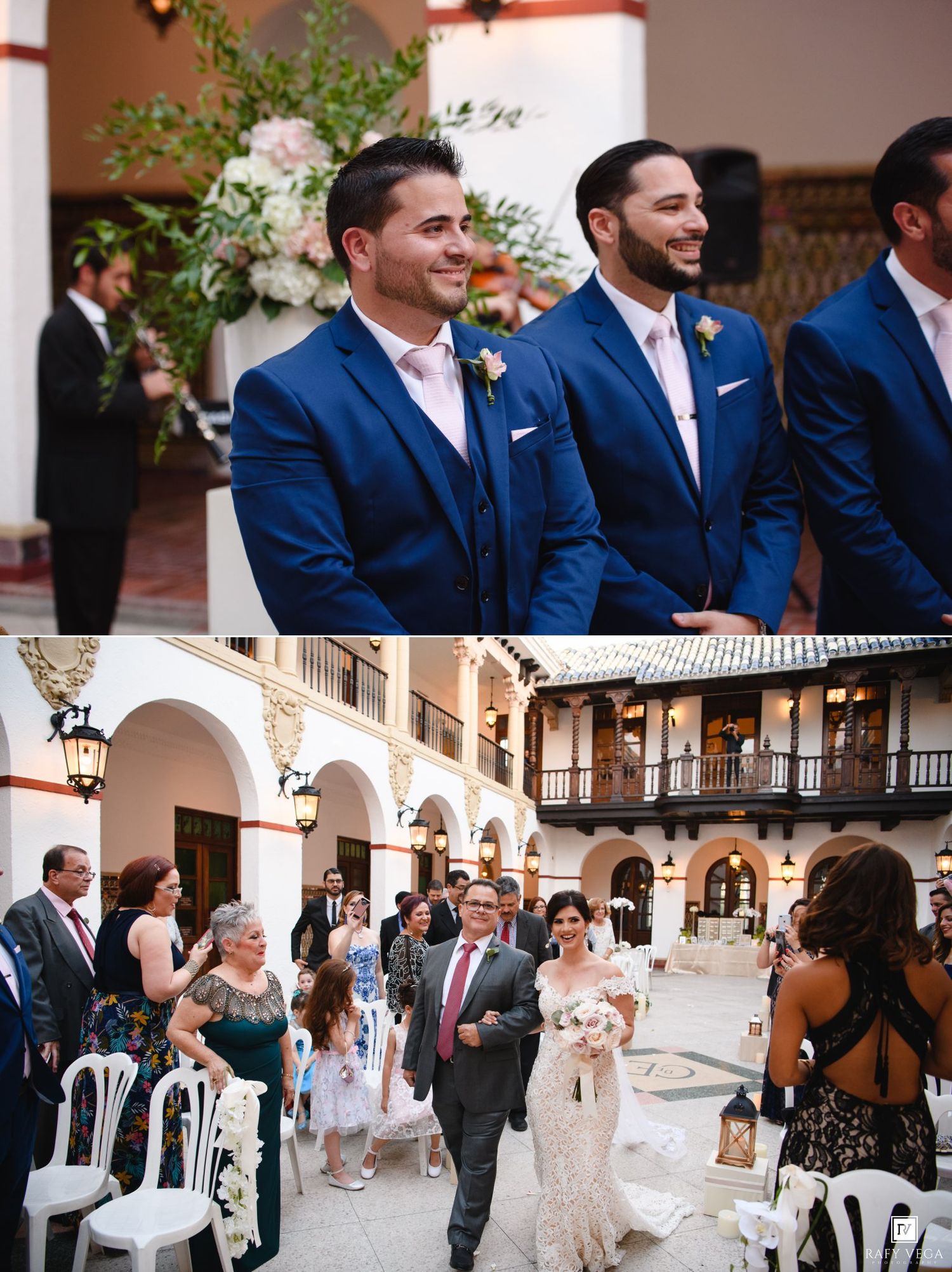 Two groomsmen in navy blue suits smile during an outdoor wedding ceremony in a Spanish-style courtyard venue.