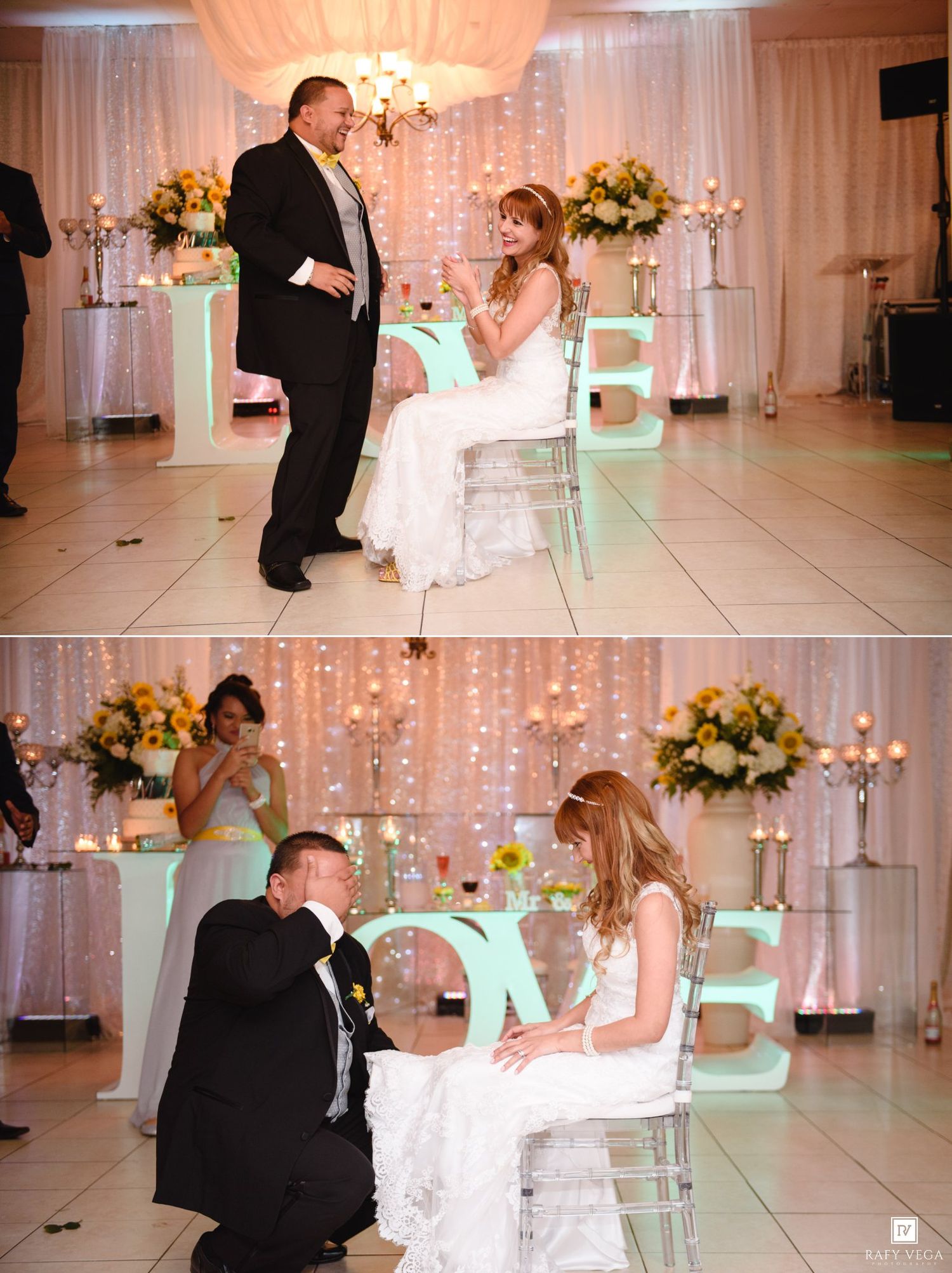 Bride and groom share a romantic garter removal moment at elegant wedding reception with LOVE letters and floral decor.