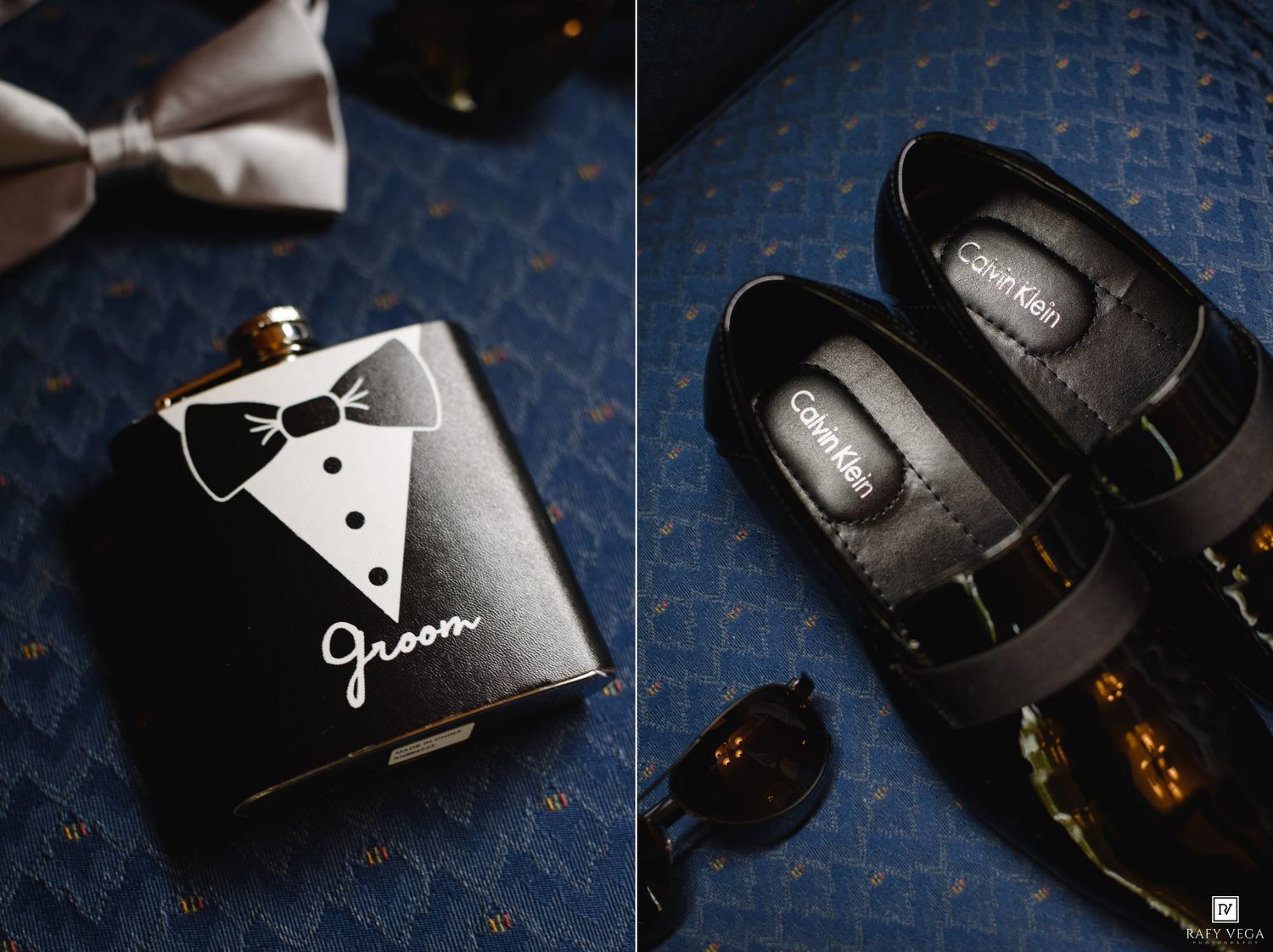 Black groom hip flask and Calvin Klein dress shoes displayed on blue fabric for a wedding day flat lay.
