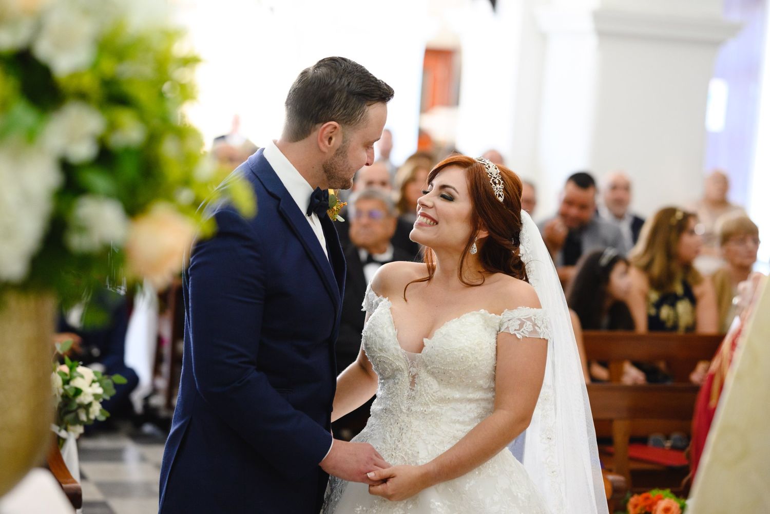 Bride and groom share a romantic moment at the altar during their church wedding ceremony.