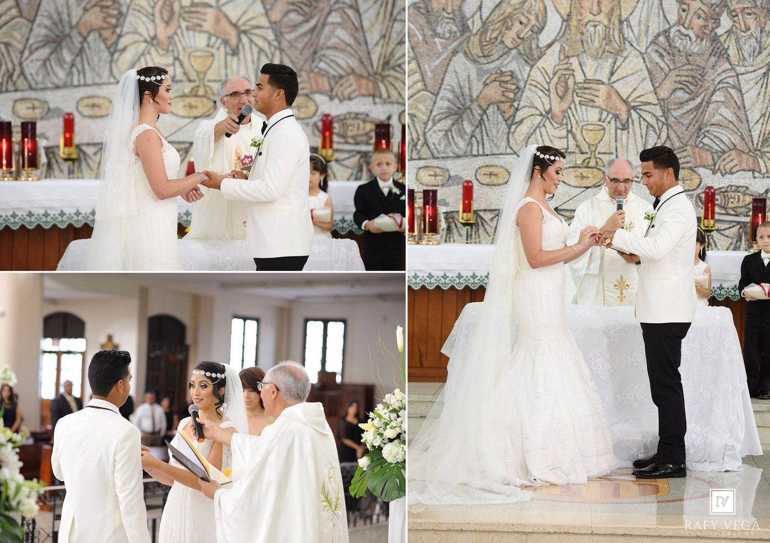 Bride and groom exchange rings during a Catholic church wedding ceremony with white decor and red candles.