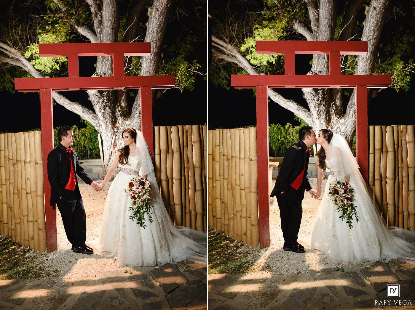 Bride and groom holding hands under a red torii gate with bamboo fence backdrop at an outdoor wedding ceremony.