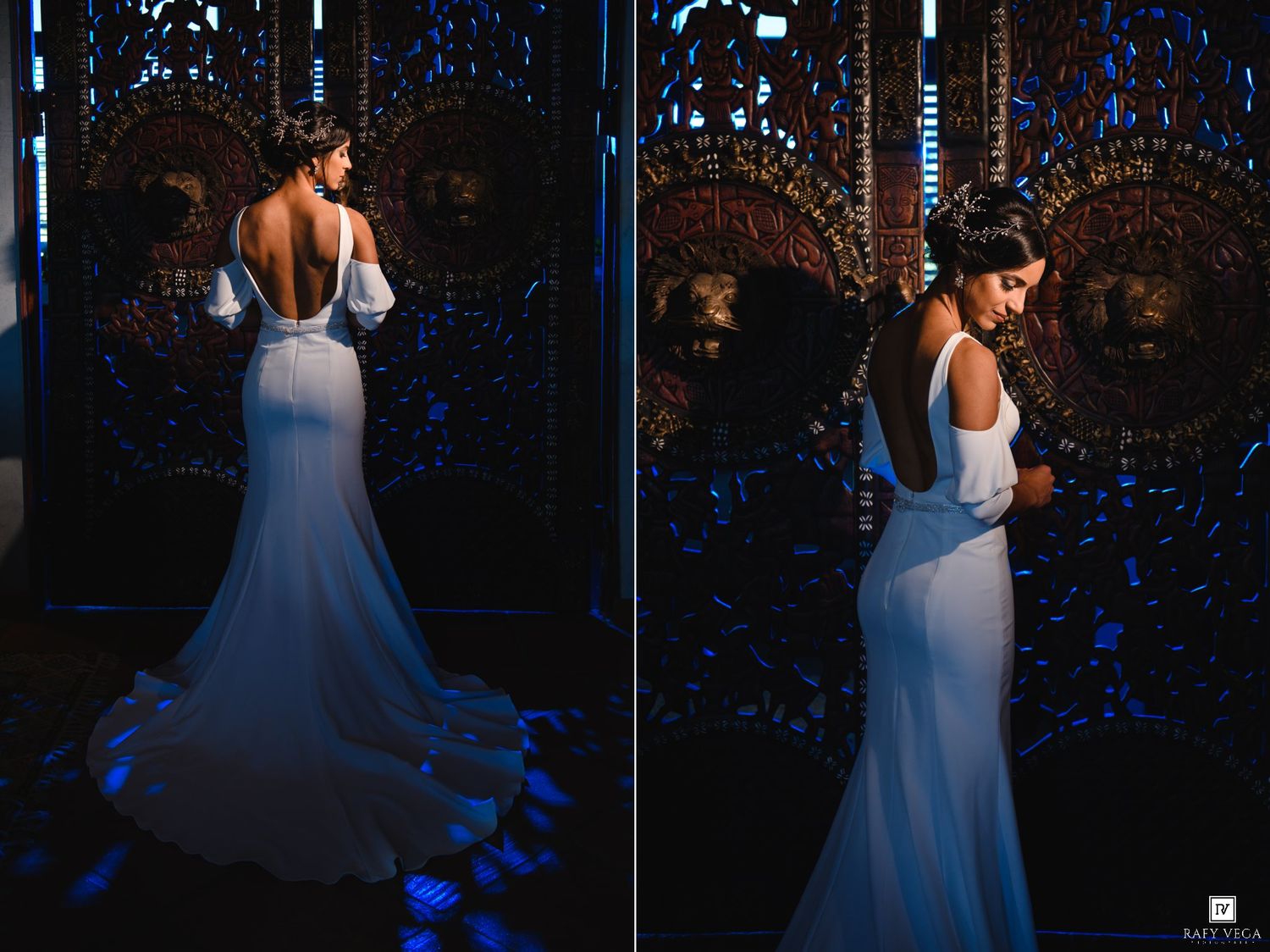 Elegant bride in a white backless mermaid gown with train, posed against ornate blue-lit decorative panels.