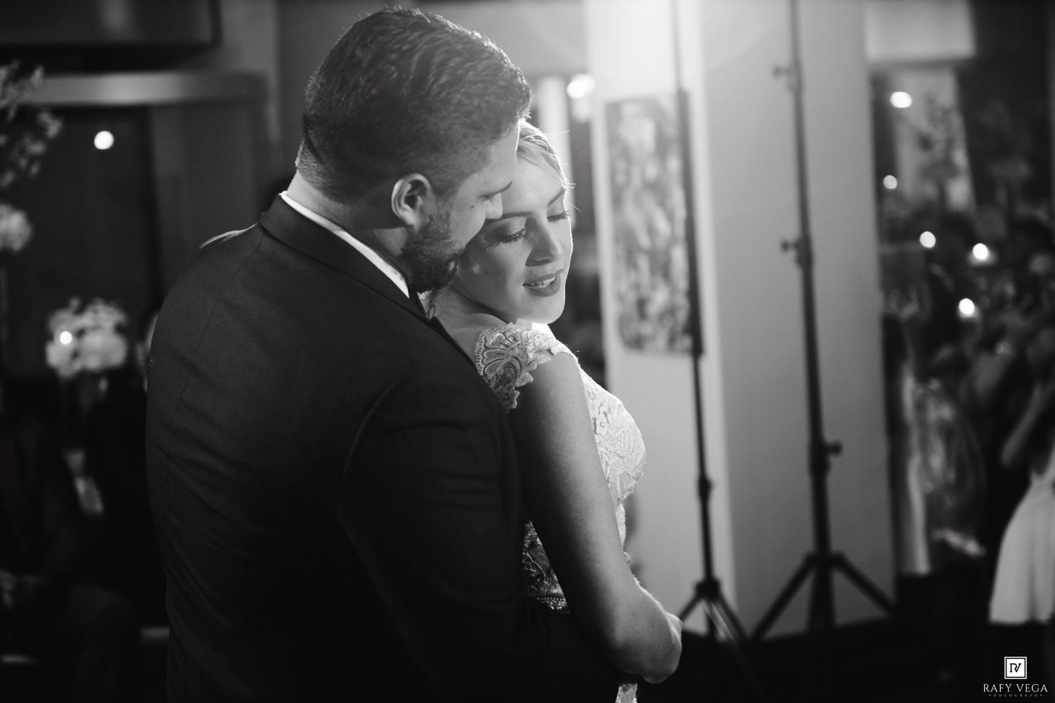 Romantic black and white photo of bride and groom sharing an intimate first dance.