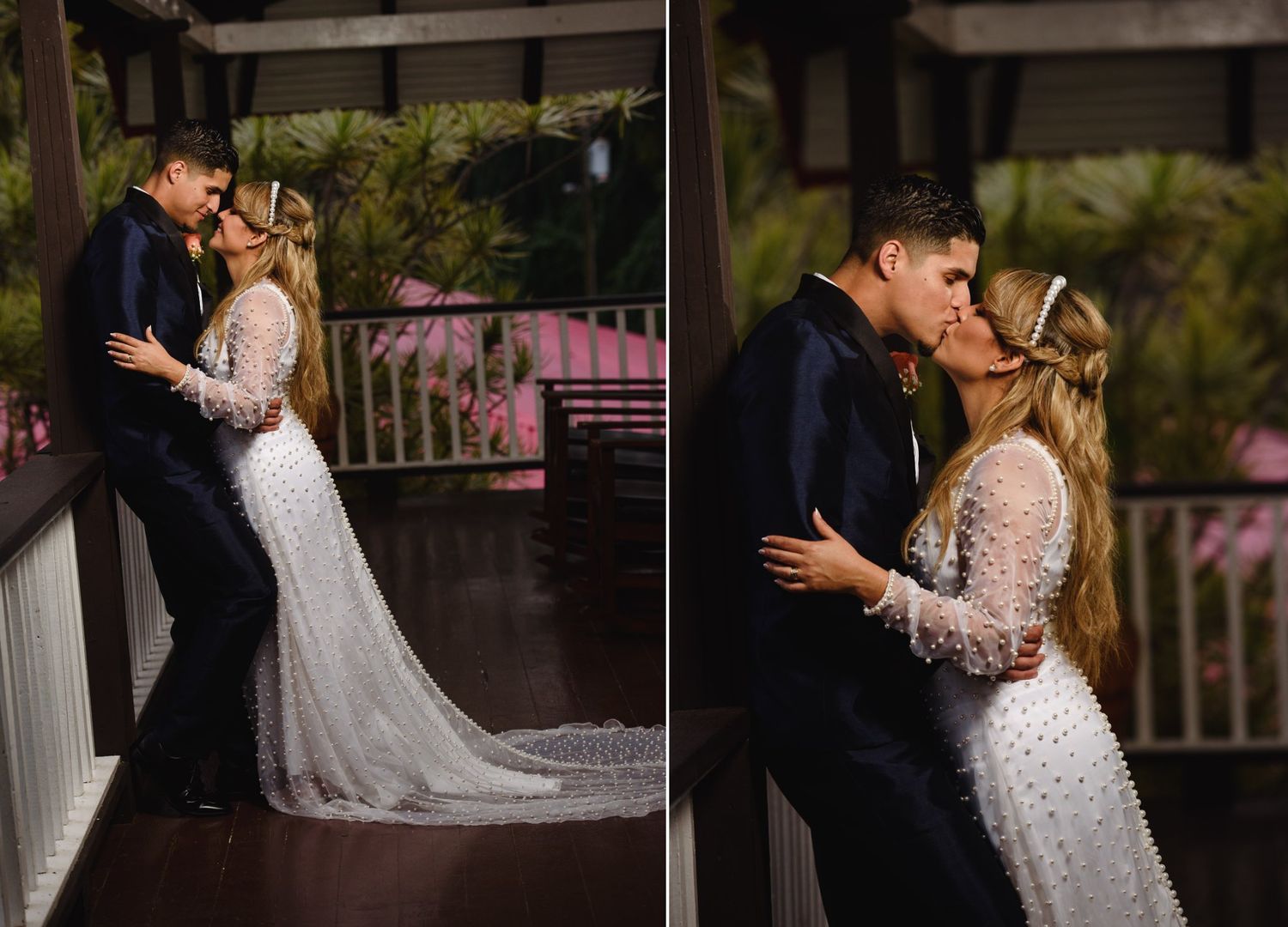 Bride and groom share a romantic kiss on a porch, bride wearing a long lace wedding dress.