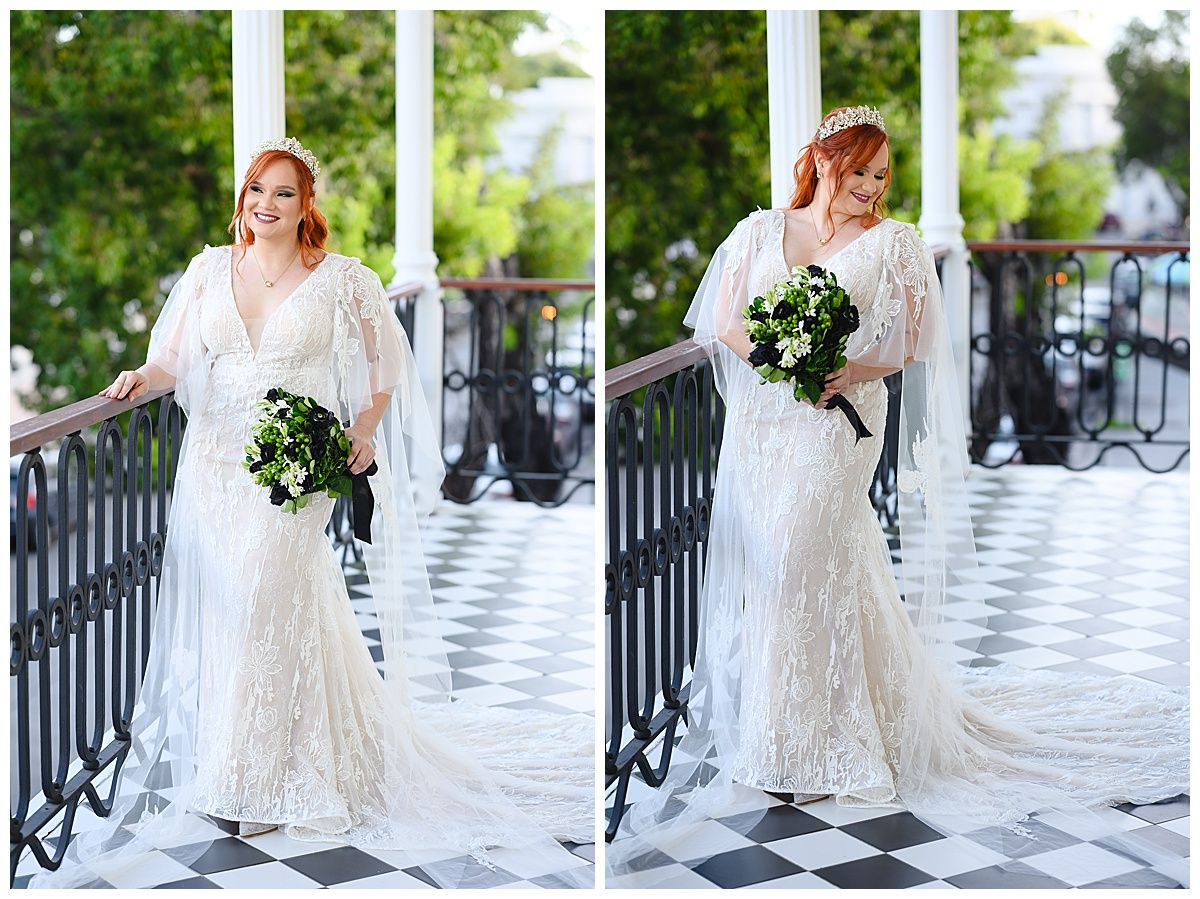 Red-haired bride in lace mermaid gown holds green bouquet on black and white checkered balcony.