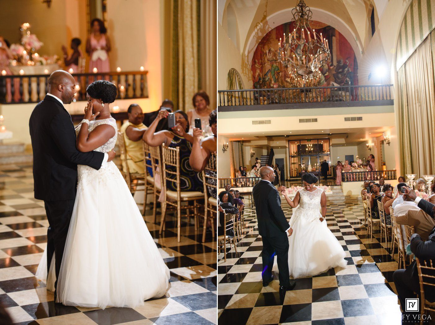 Bride and groom share first dance on checkered floor in elegant chandelier-lit ballroom during wedding reception.