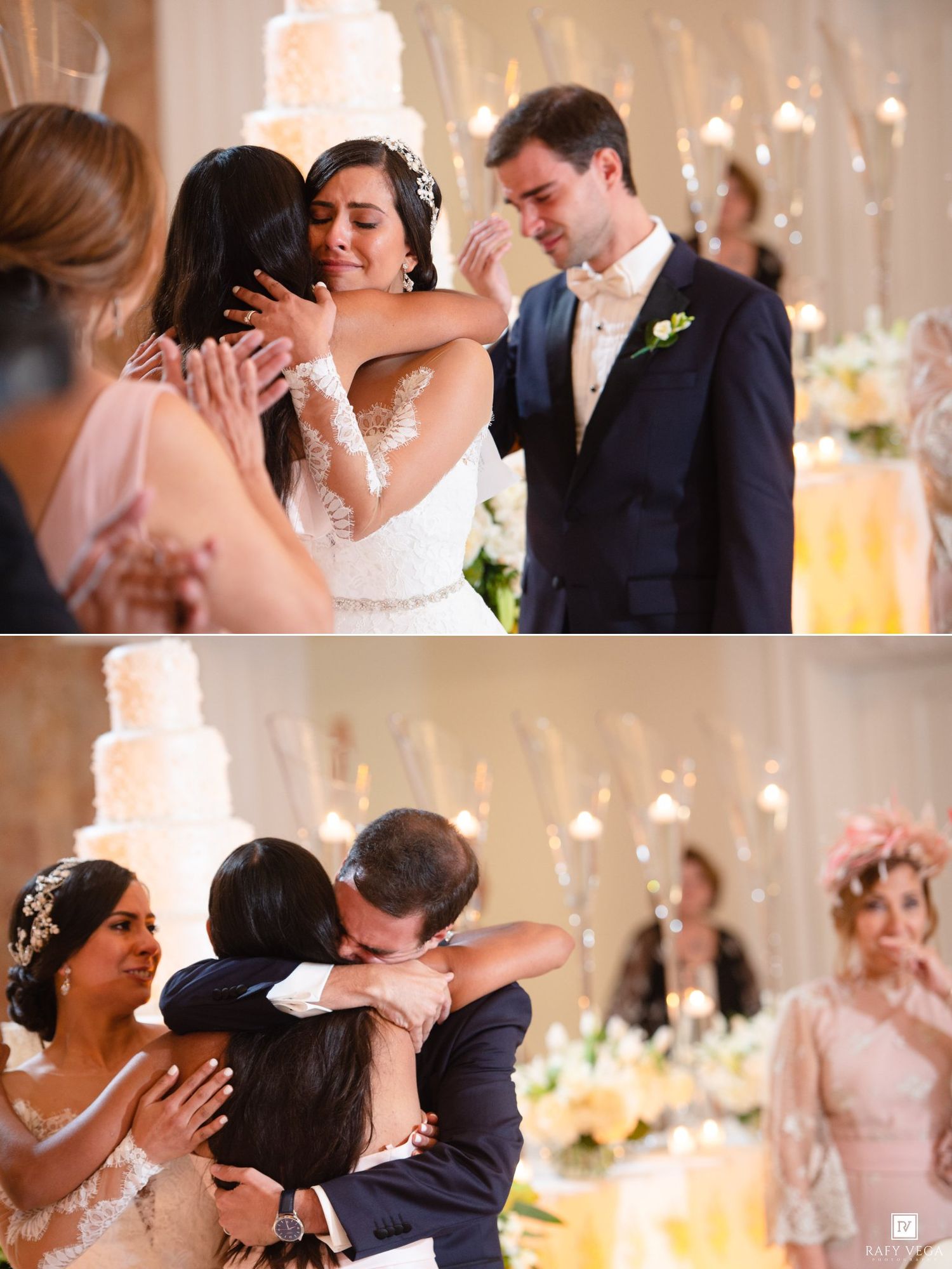 Emotional wedding reception moment as bride hugs guests while groom watches, with elegant tiered cake in background.