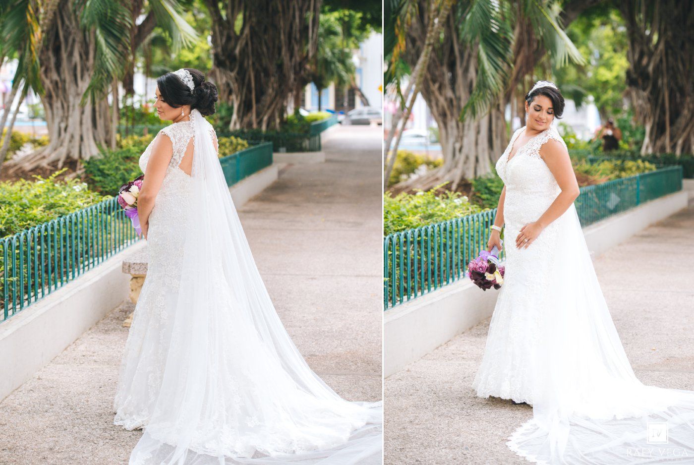 Elegant bride in a white lace gown with long train holds a bouquet in a lush garden setting.