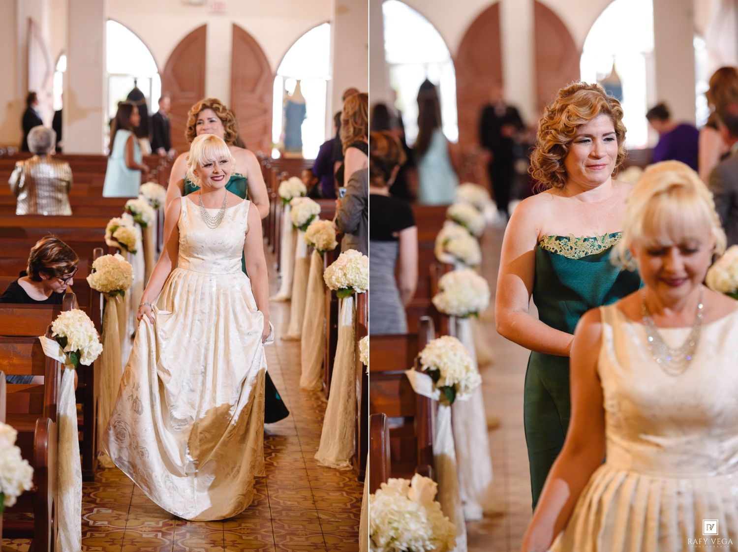 Bridesmaids in colorful dresses walk down church aisle carrying white floral bouquets during wedding ceremony.