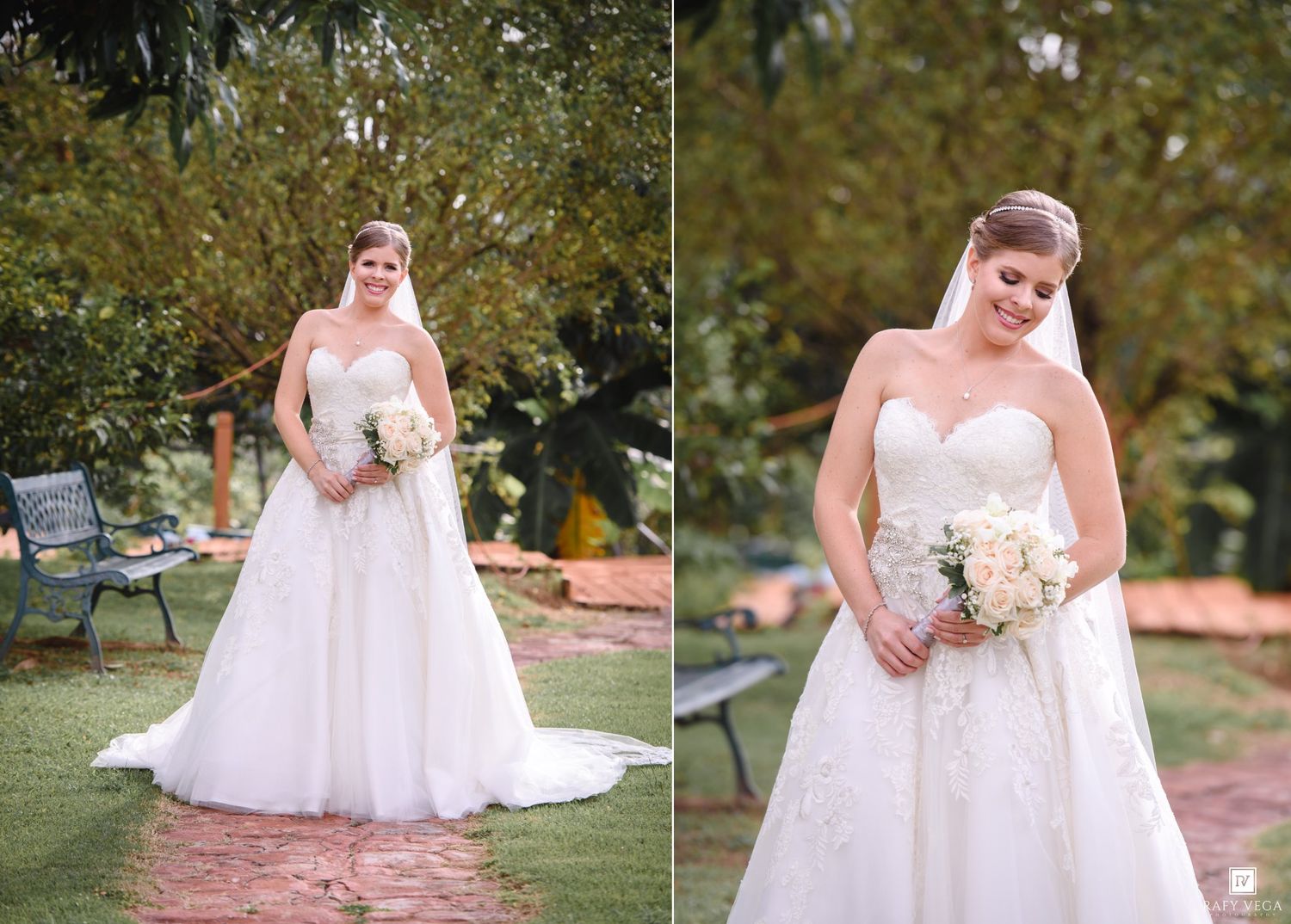 Bride in strapless lace A-line wedding gown holding white bouquet poses outdoors in garden setting with lush green trees.