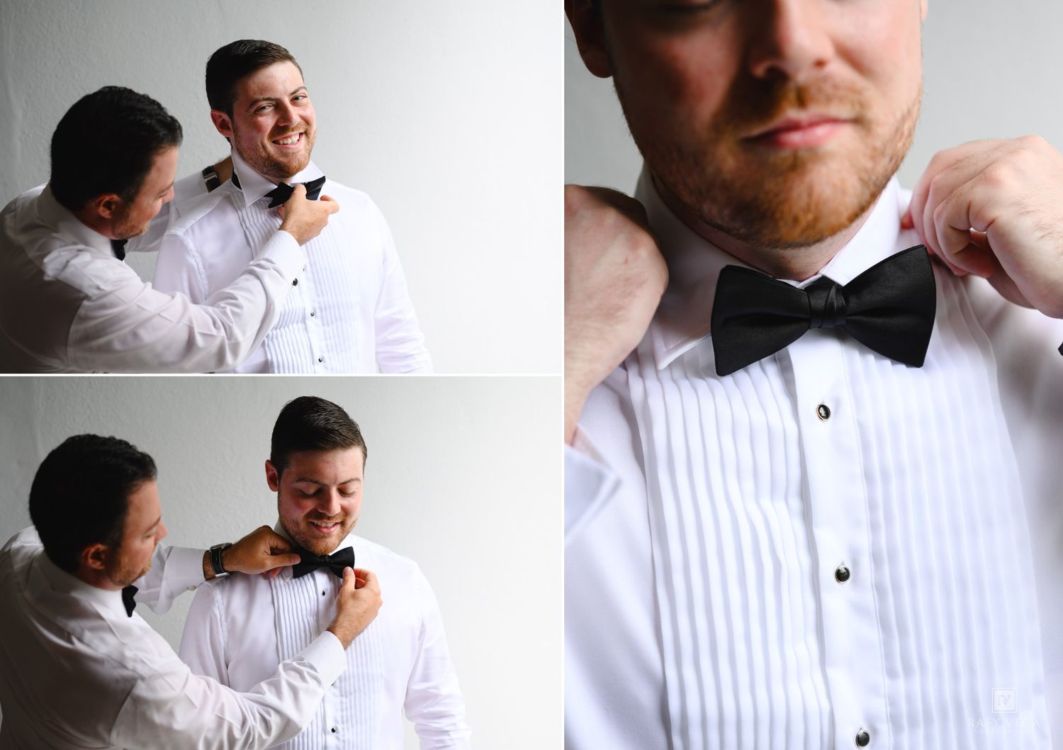 Two groomsmen in white tuxedo shirts adjusting black bow ties while getting ready for a wedding ceremony.