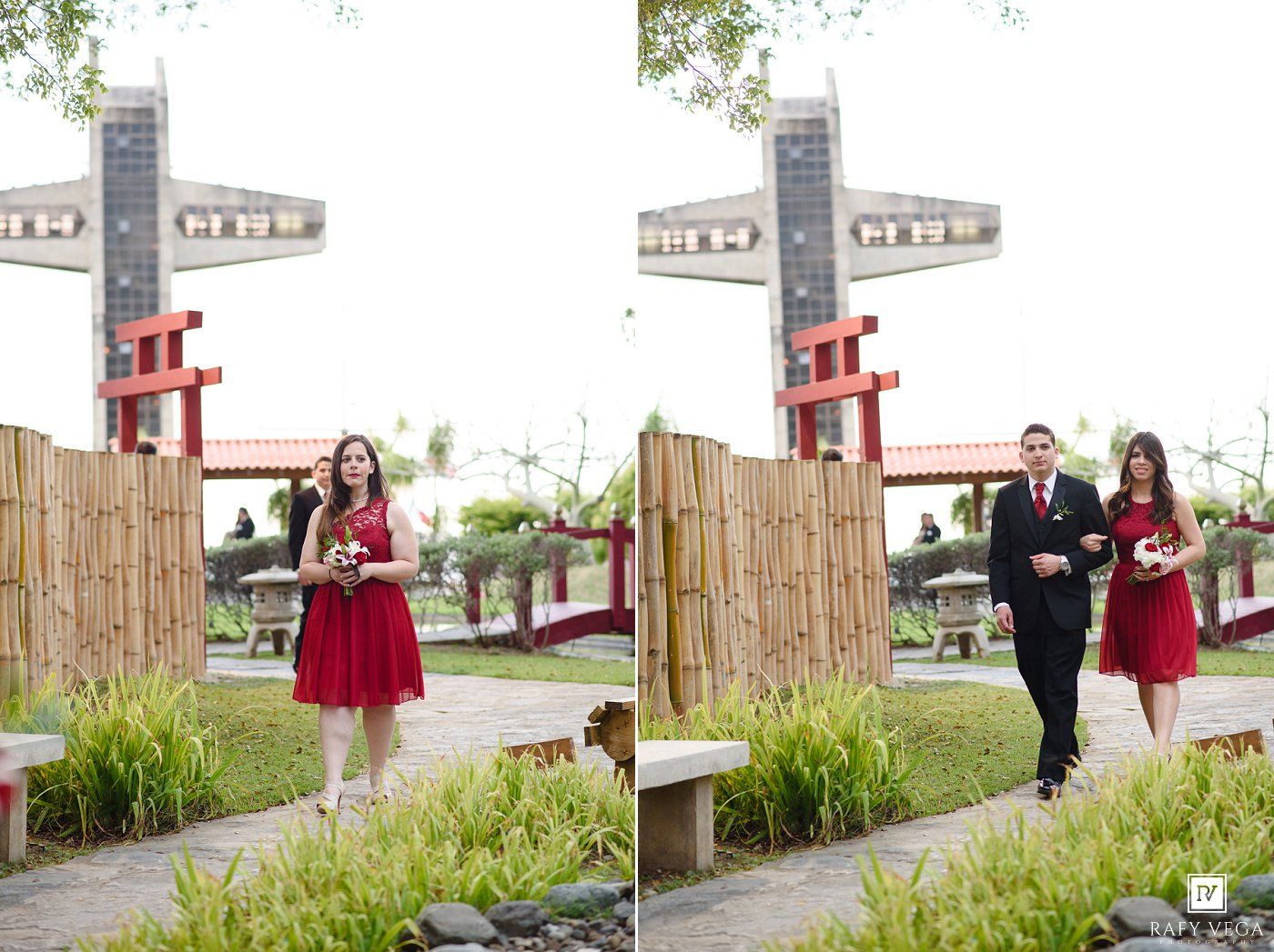 Bridesmaid in red dress walks with groomsman in black suit at outdoor wedding venue with bamboo fence.