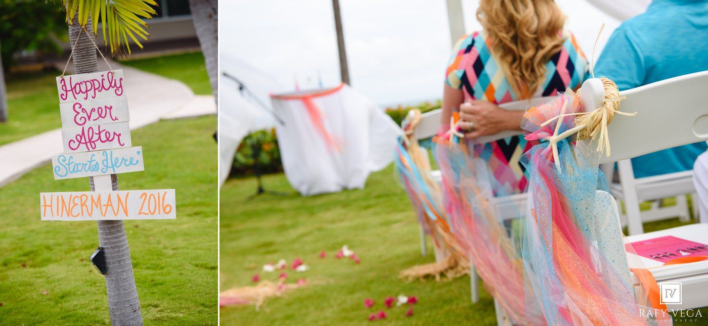 Colorful outdoor wedding ceremony decor with ribbons on chairs and a handmade Happily Ever After wooden sign.