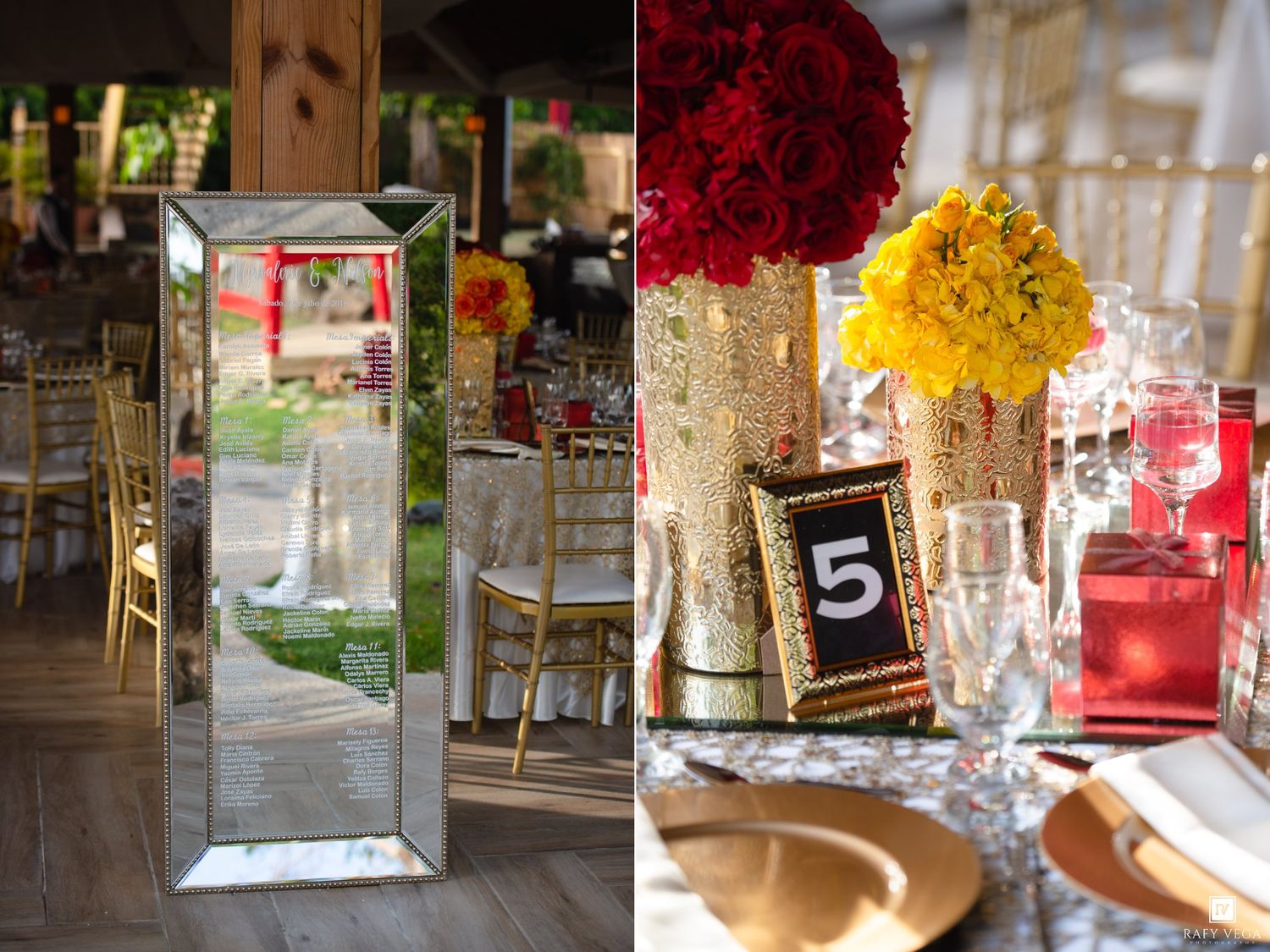 Elegant wedding reception with mirrored decor, gold chairs, red and yellow floral centerpieces, and table number frames.