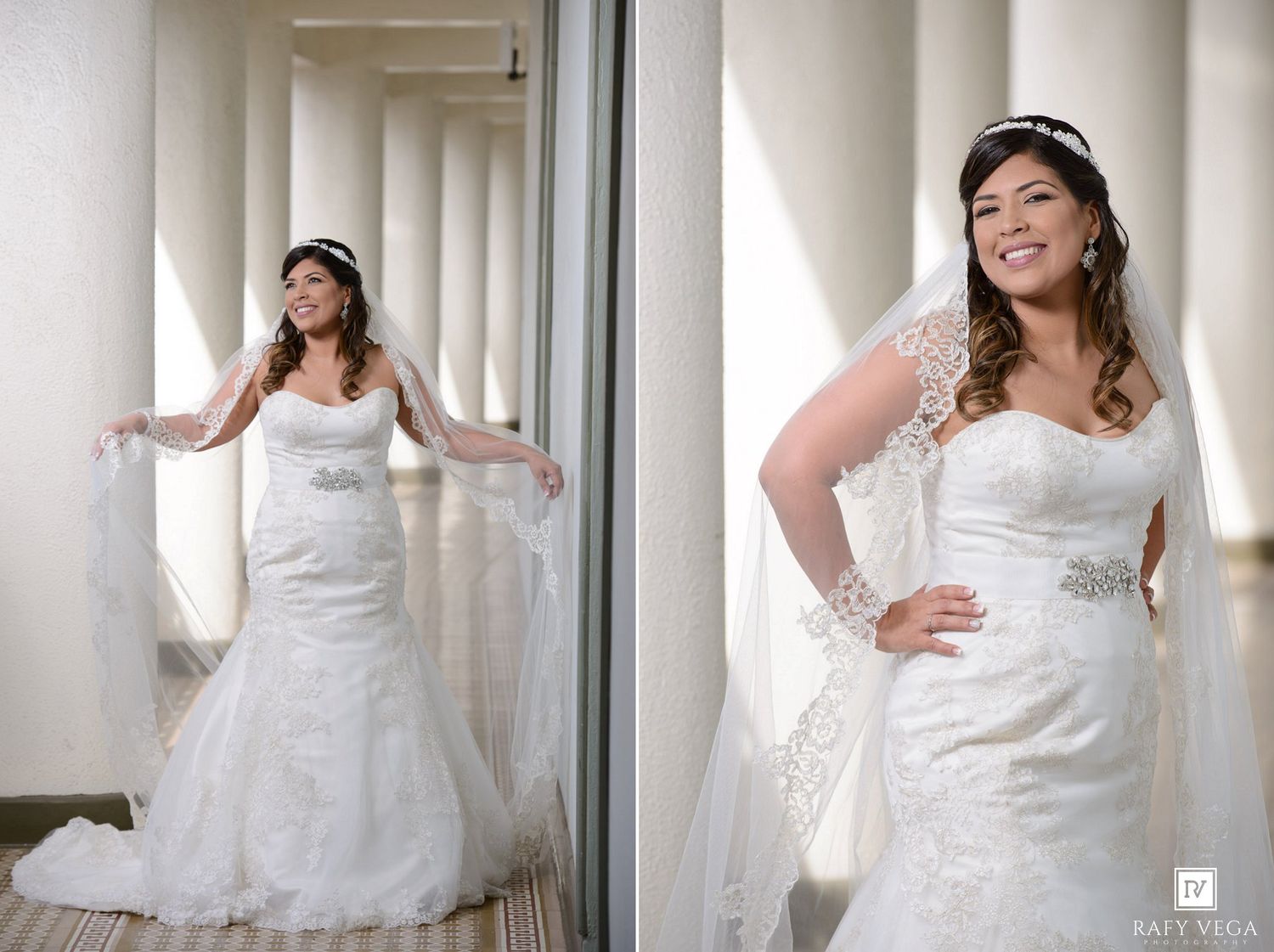 Plus-size bride in white lace mermaid wedding gown with veil and tiara posing by elegant white columns.