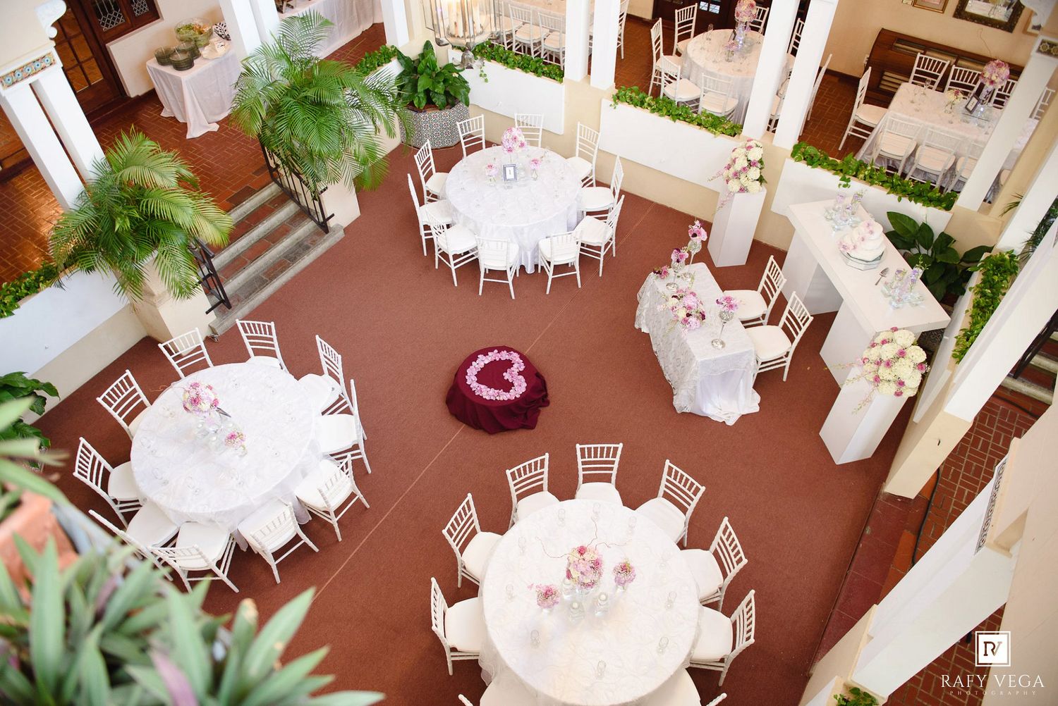 Aerial view of a elegant wedding reception venue with white round tables and chiavari chairs.