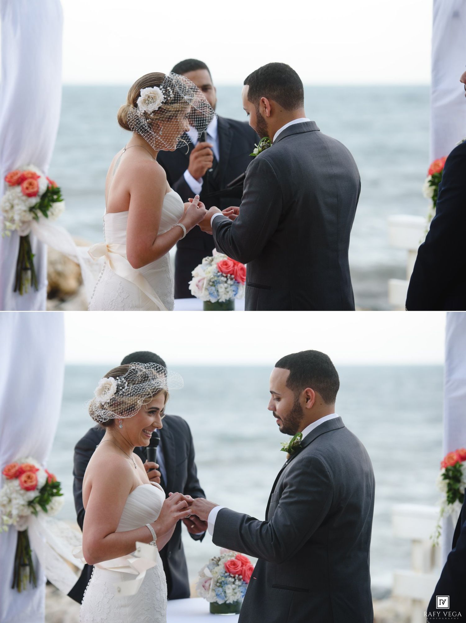 Bride and groom exchanging rings during an outdoor beach wedding ceremony with coral floral arrangements.