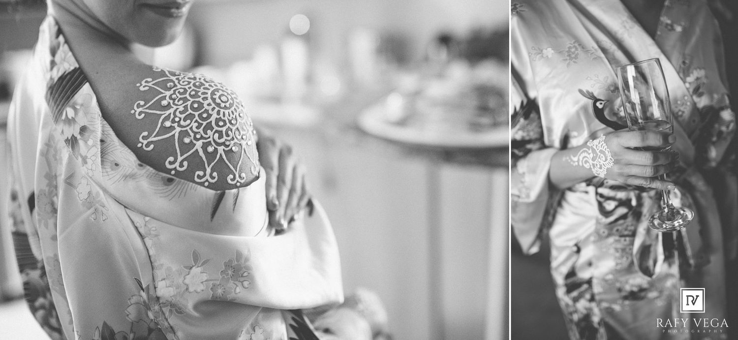 Black and white photo of a bride in a floral kimono robe with a henna tattoo on her shoulder, preparing for her wedding day.