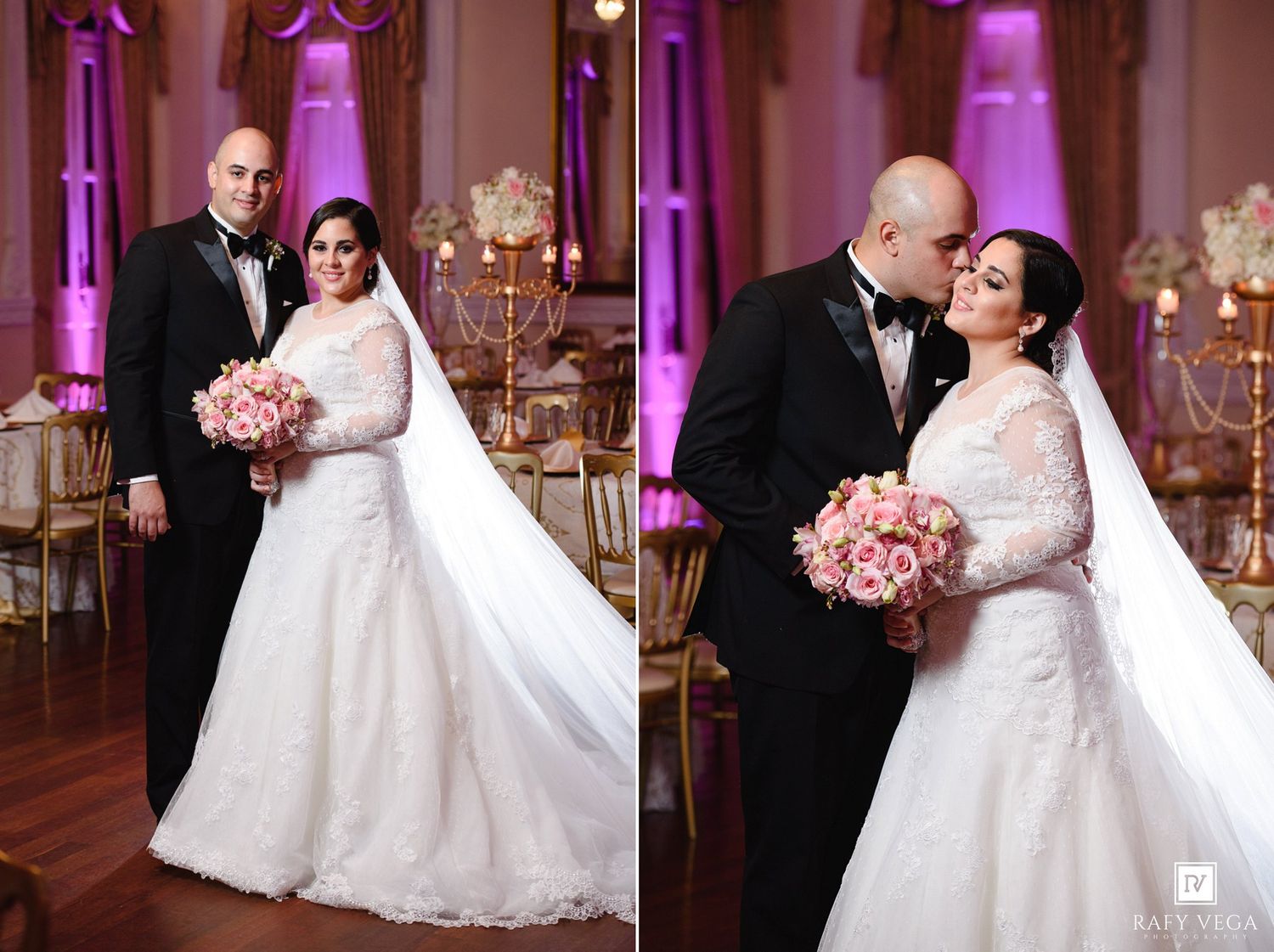 Bride in lace gown and groom in tuxedo pose together in pink-lit ballroom during wedding reception.