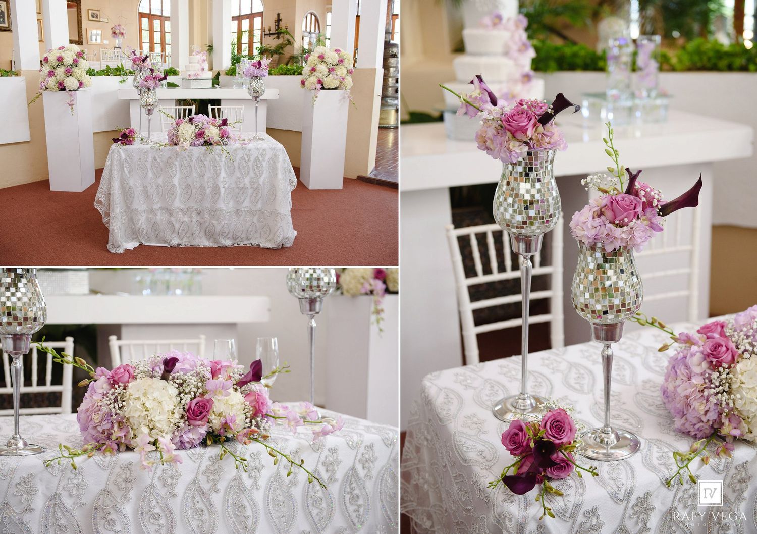 Elegant wedding reception table with white lace linens, tall silver vases, and pink and purple floral arrangements.