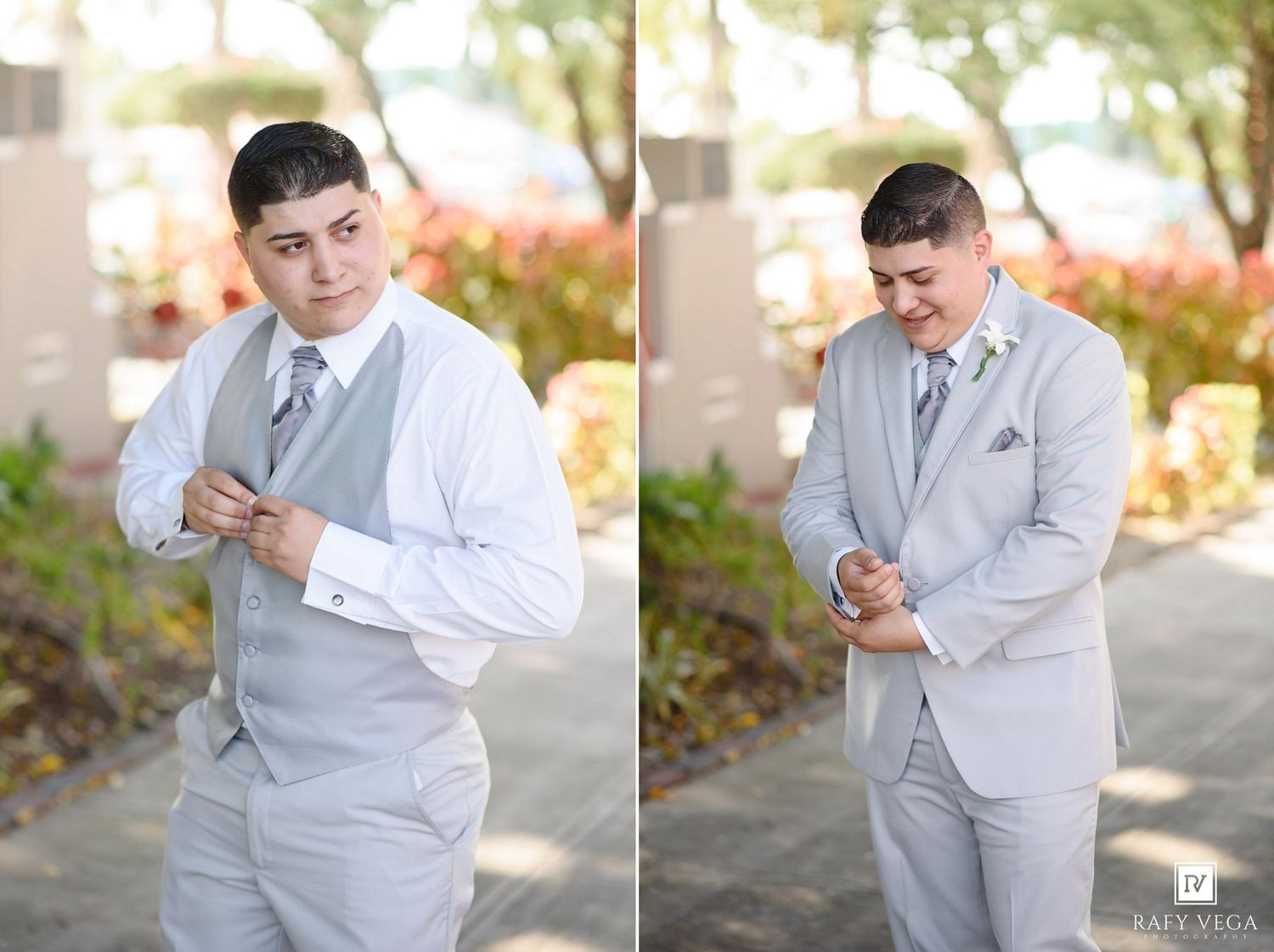 Young groom in light gray suit adjusting his tie and cufflinks outdoors before wedding ceremony.
