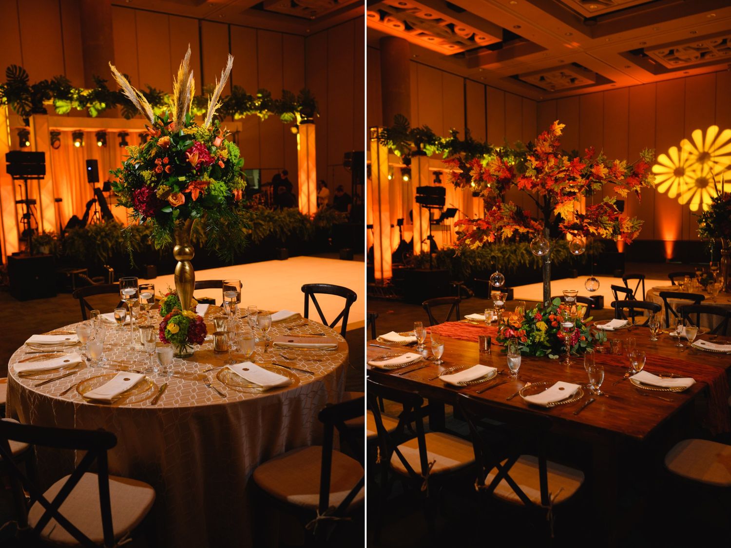 Elegant wedding reception tables with lush floral centerpieces and warm amber uplighting in a ballroom.
