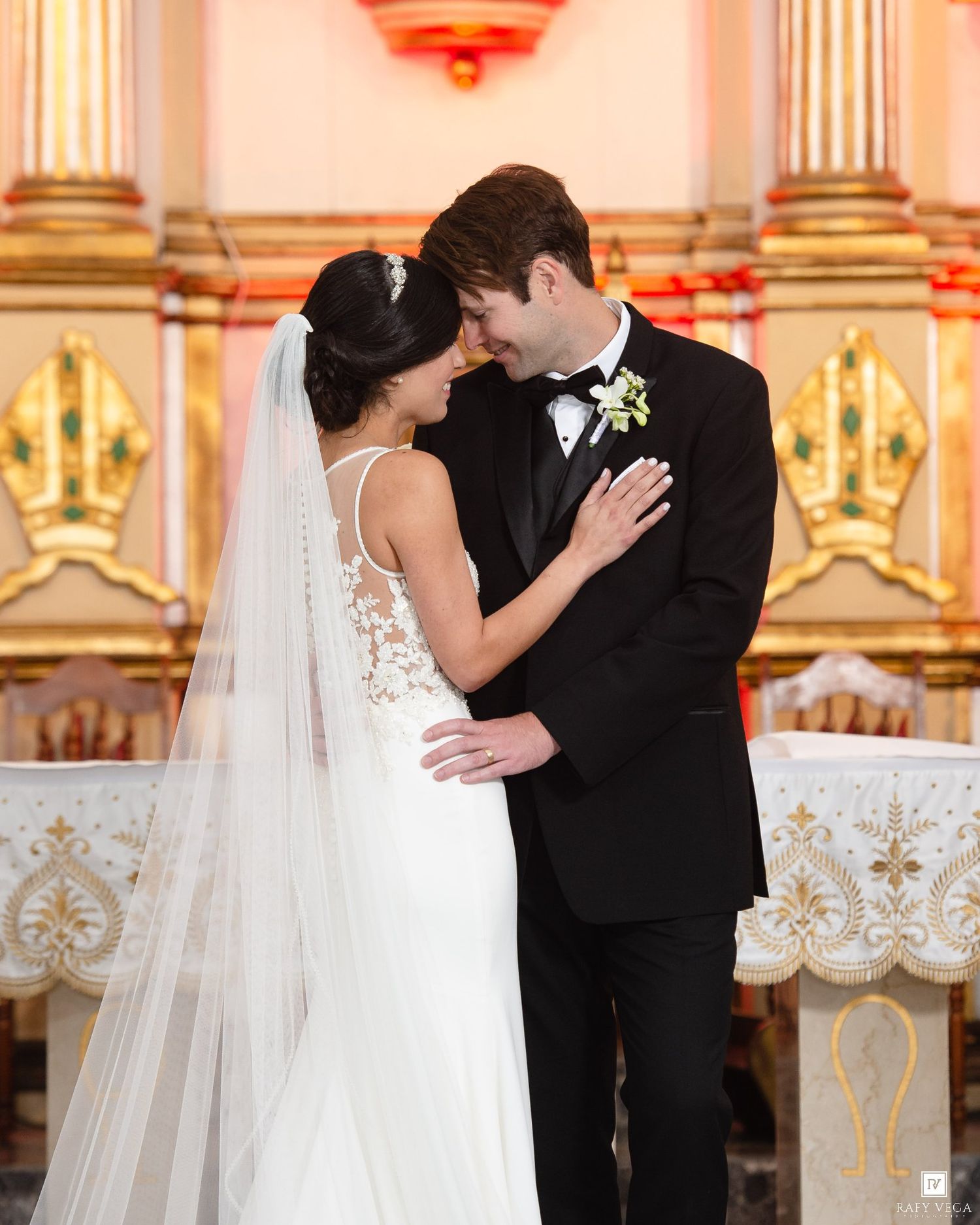 Bride and groom share a romantic moment at the altar in a stunning church wedding ceremony.