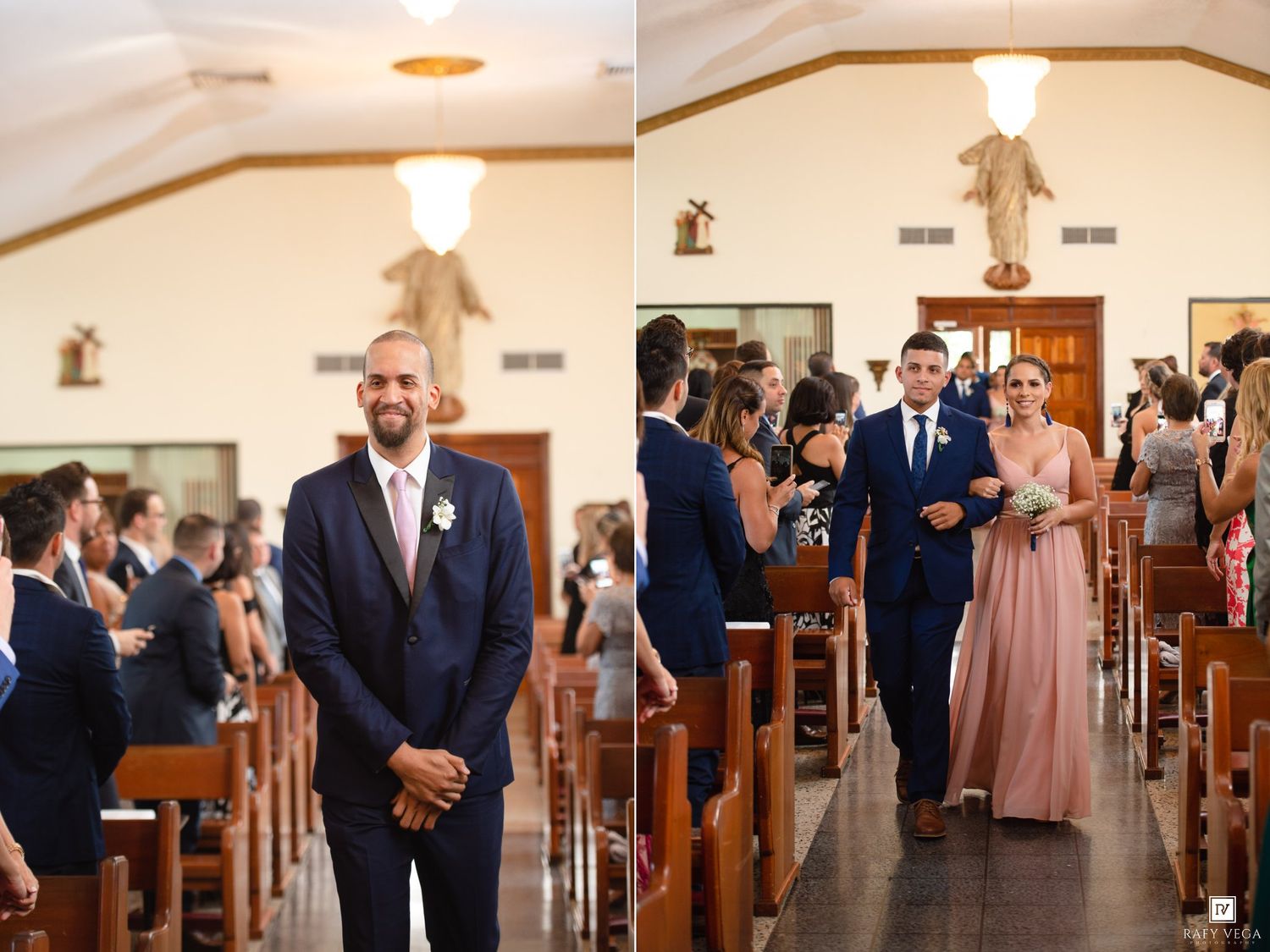 Groom in navy suit smiles at altar as bridesmaid in pink dress escorts groomsman down church aisle.