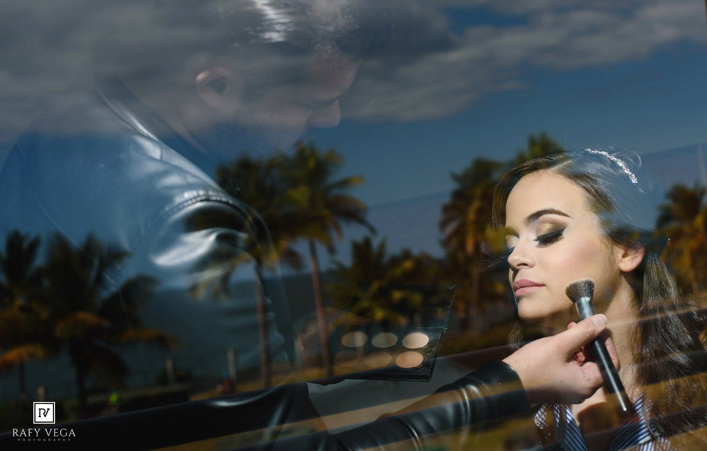 Woman posing near car window with palm trees reflected, captured by Rafy Vega photography in Miami.
