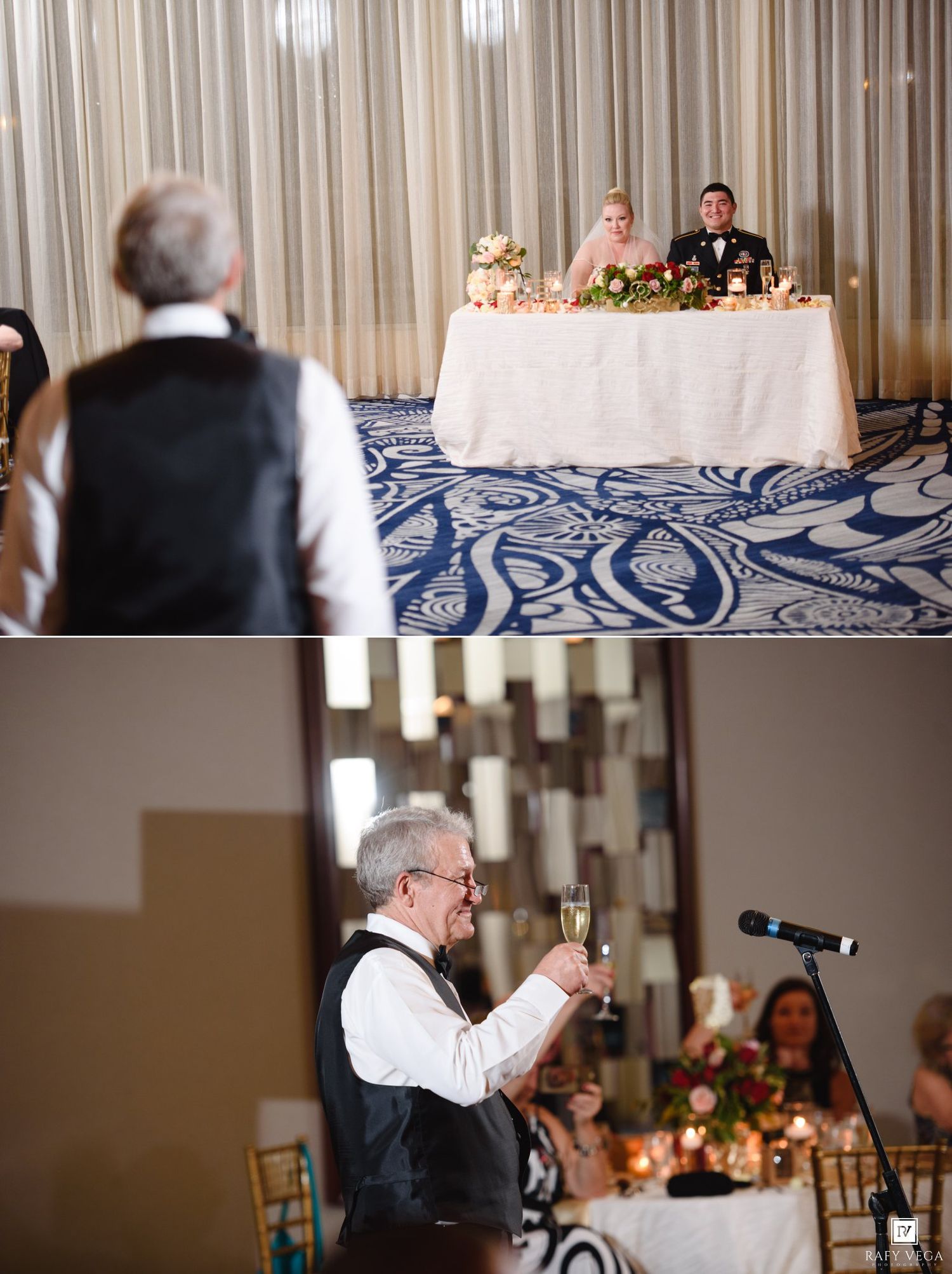 Bride and groom seated at sweetheart table while father delivers champagne toast at elegant wedding reception.
