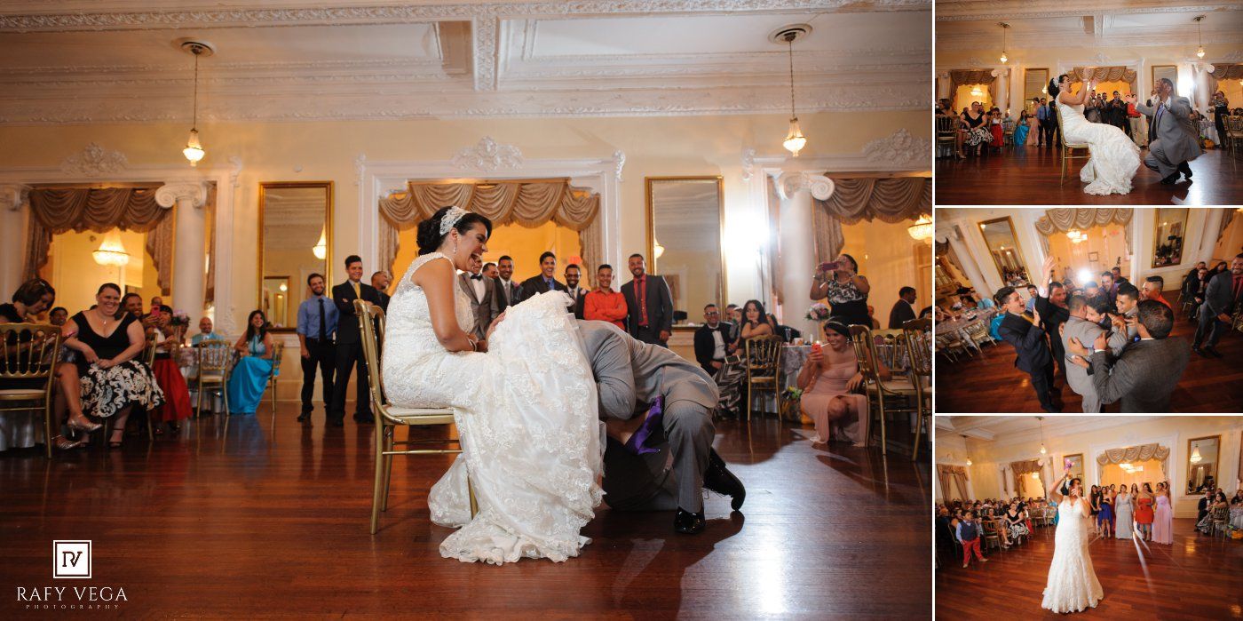 Groom removes bride's garter during fun wedding reception tradition on the dance floor.