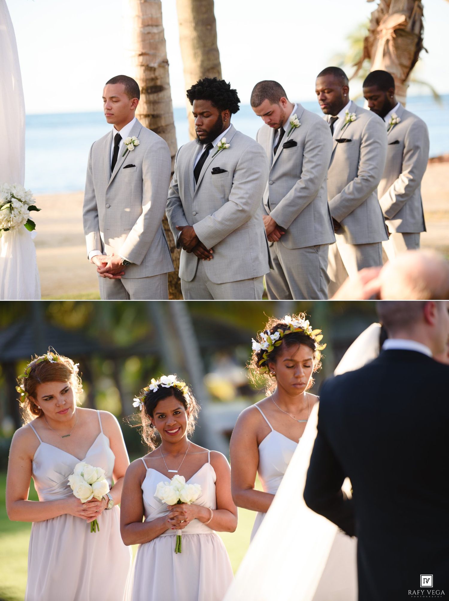 Groomsmen in gray suits and bridesmaids in white dresses with floral crowns at a tropical beach wedding ceremony.