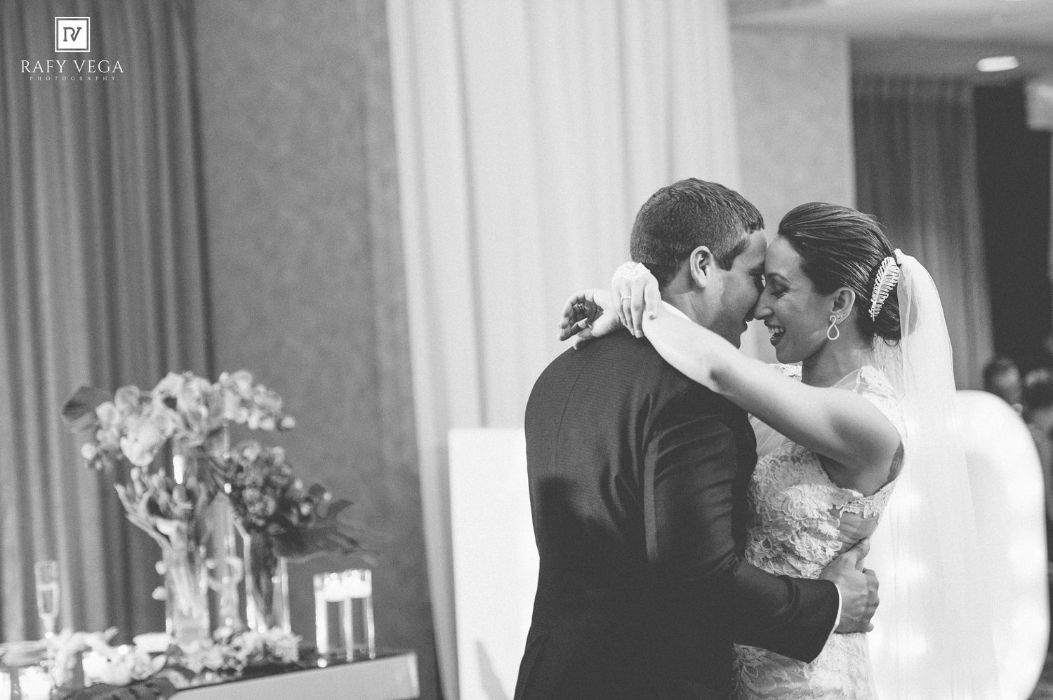 Black and white photo of bride and groom sharing an intimate first dance at their elegant wedding reception.