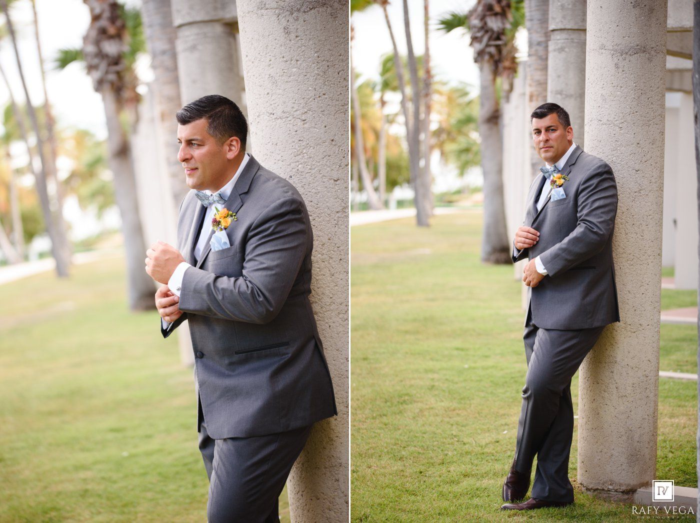 Groom in gray suit with yellow boutonniere leaning against palm tree outdoors at wedding venue.
