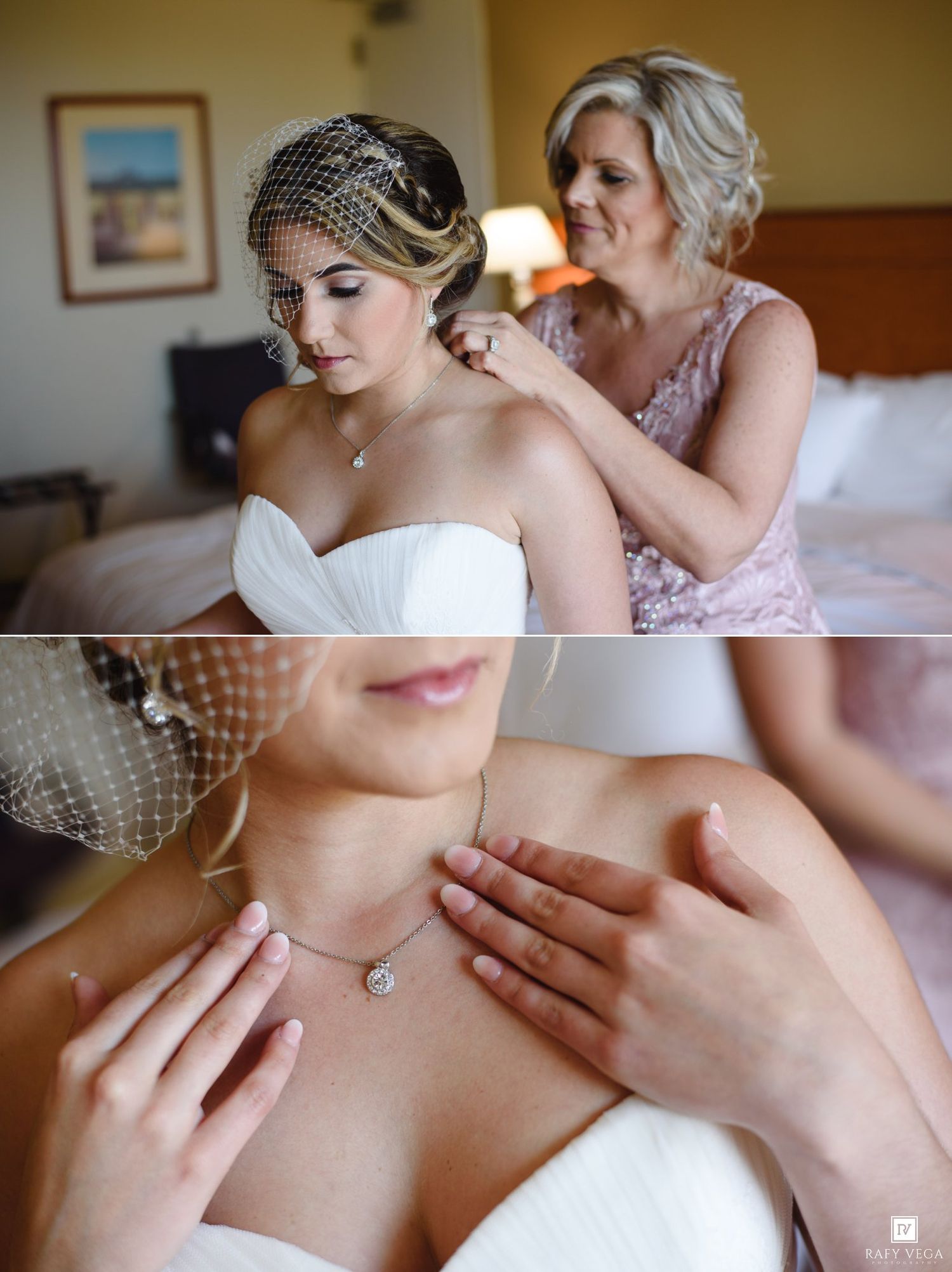 Bride getting earrings put on by bridesmaid in hotel room, wearing strapless white gown and birdcage veil.
