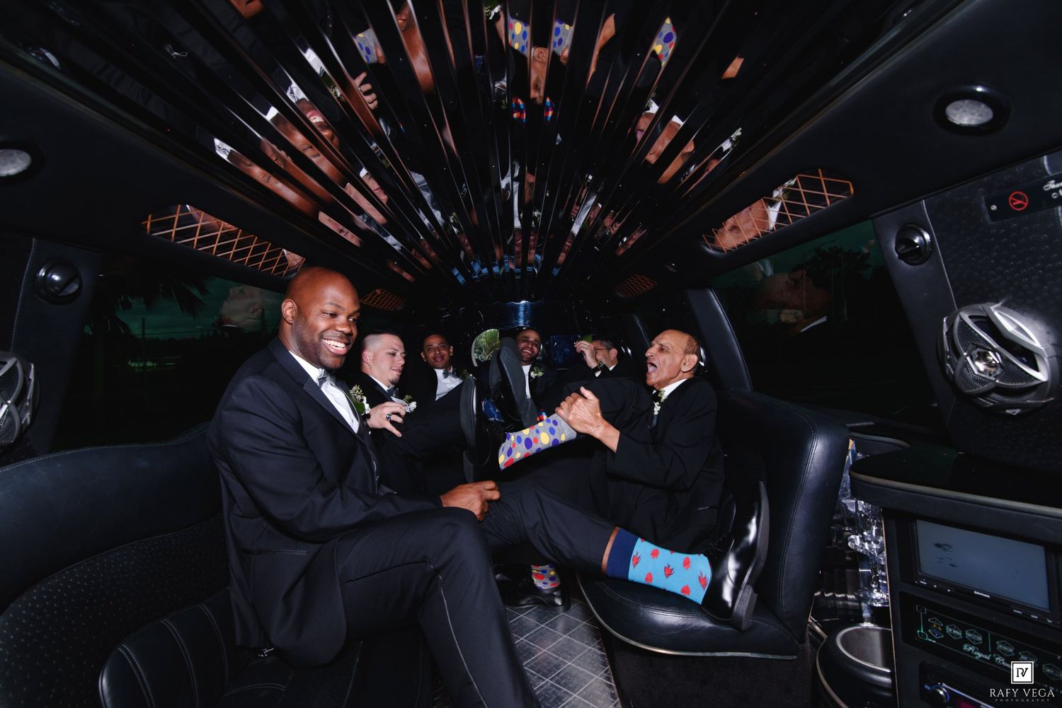 Groomsmen celebrating in decorated limousine before wedding ceremony.